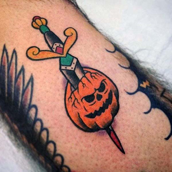 A Skull-faced Pumpkin With a Sword Going Through the Middle #Halloween #tattoos #trendypins