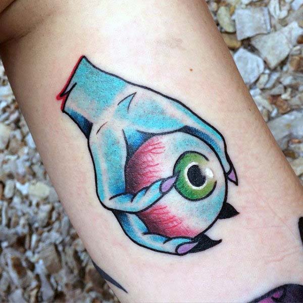 Tattoo of a Clawed Hand Holding a Giant Eye #Halloween #tattoos #trendypins