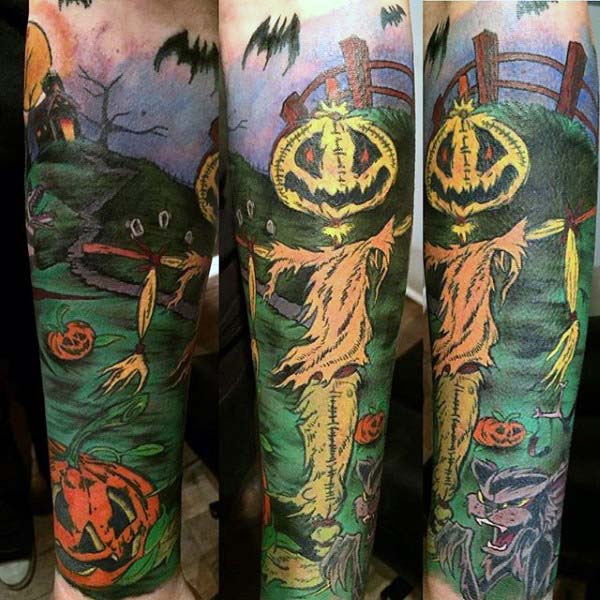 This Piece Stretches Around Your Whole Forearm, Which Features a Scarecrow, Next to a Fence #Halloween #tattoos #trendypins