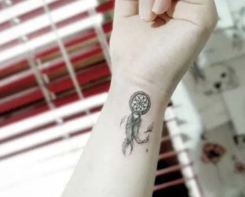 Small dream catcher tattoo on wrist