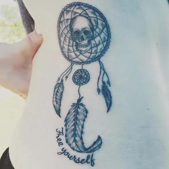 small dreamcatcher tattoo on ribs