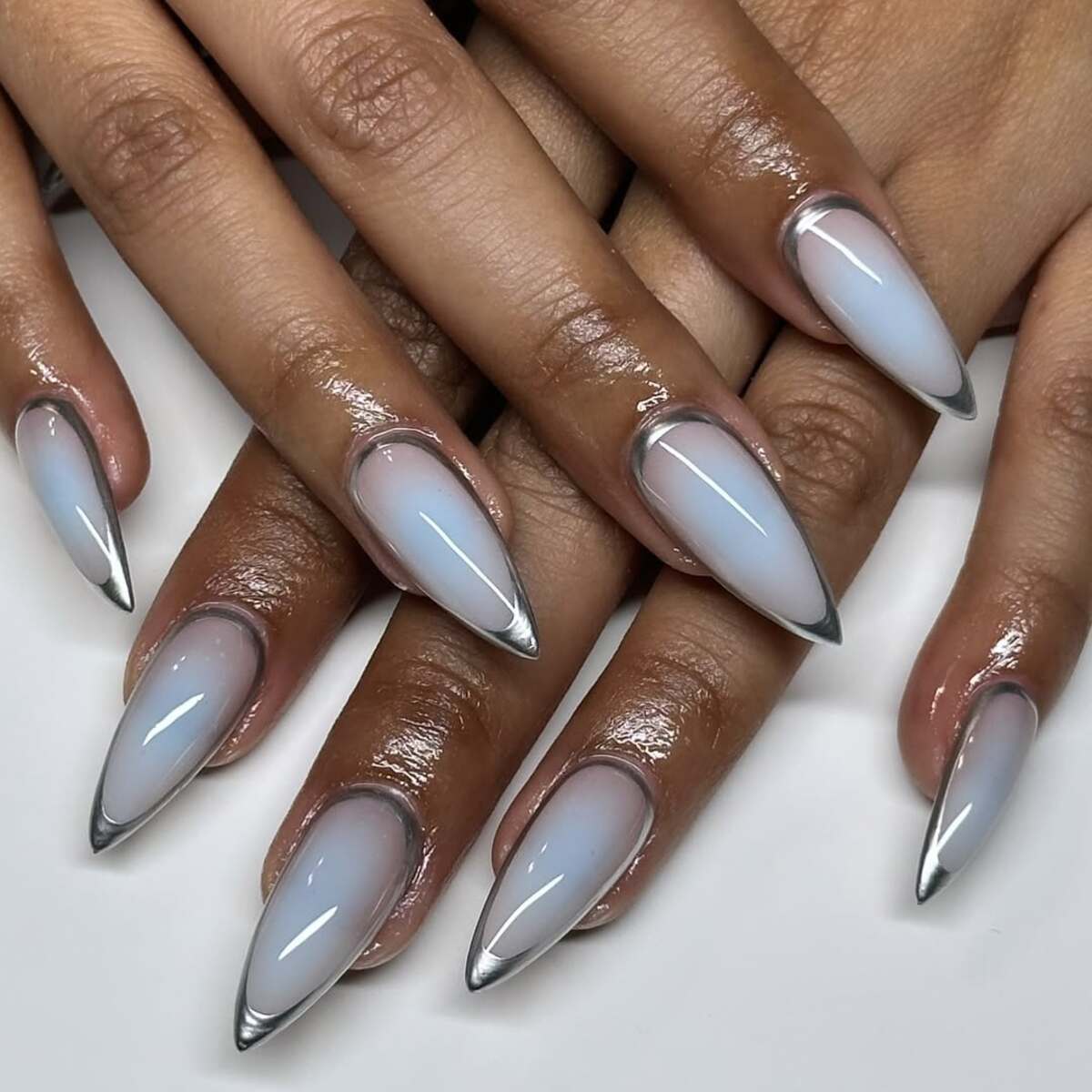 1. Futuristic Chrome-Tipped Stiletto Nails