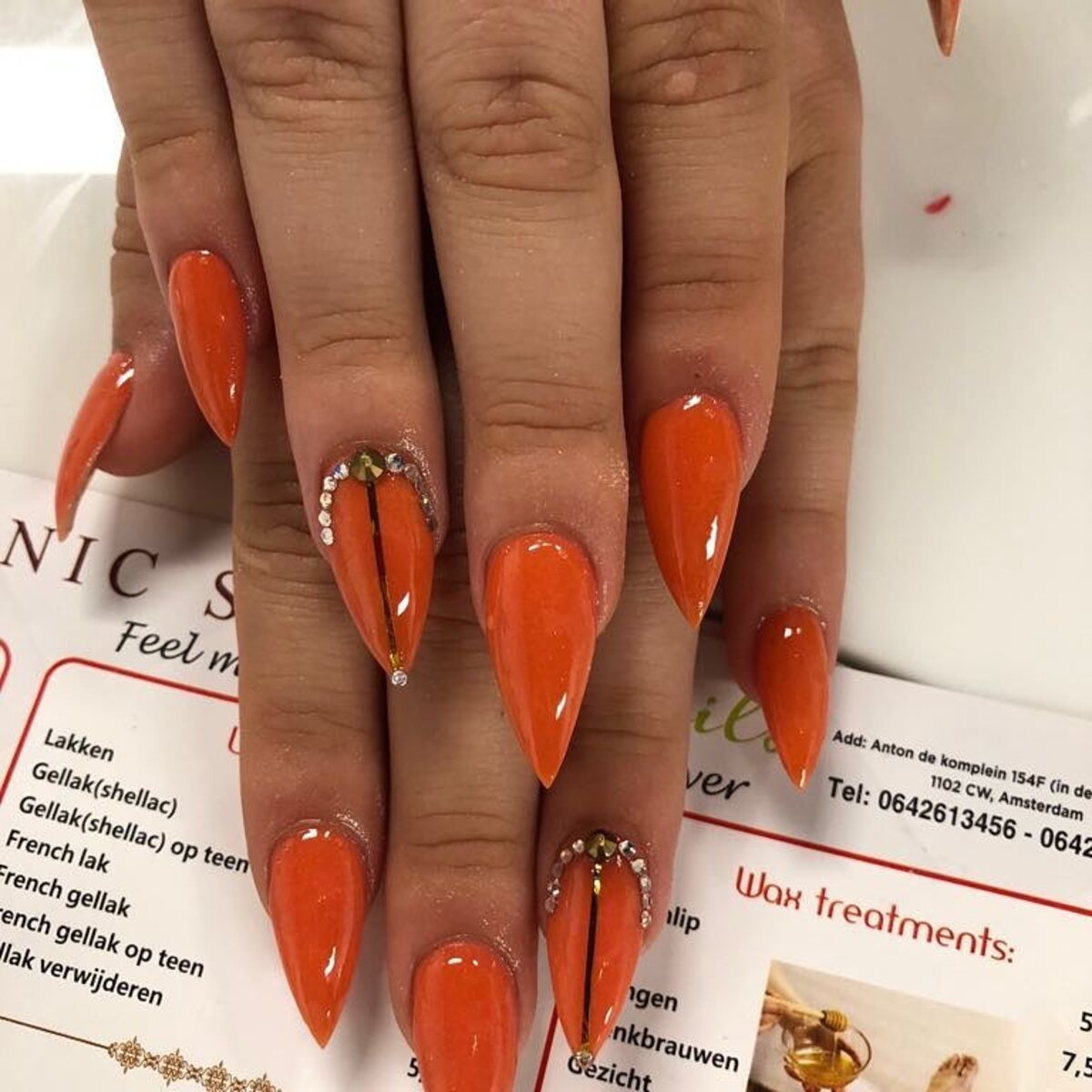 14. Fiery Orange Stilettos with Rhinestone Accents