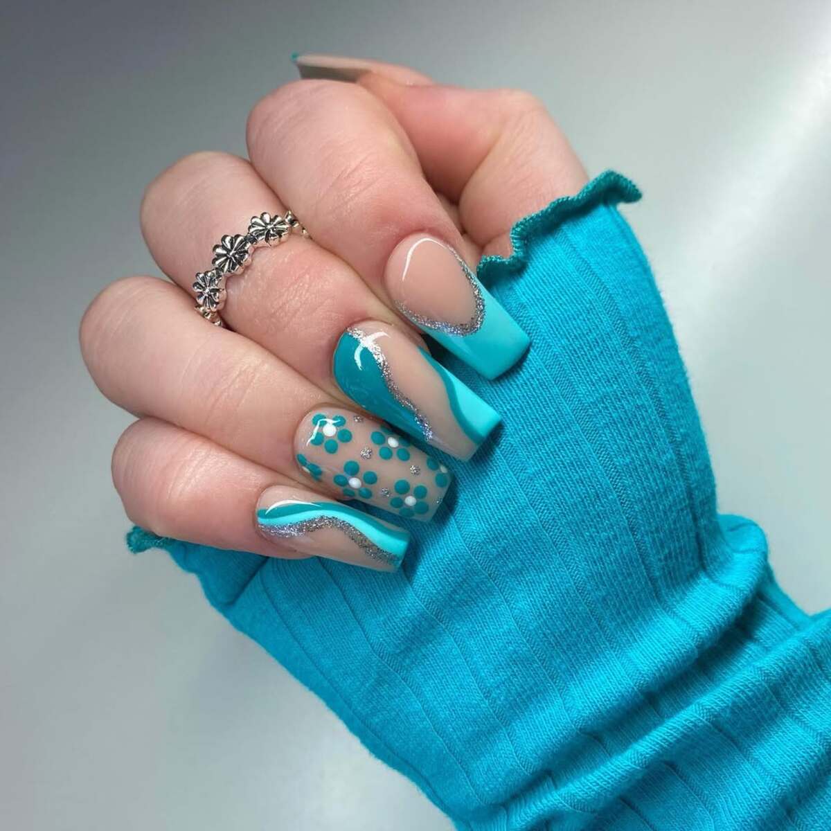 13. Ocean-Inspired Blue Acrylics with Floral Accents