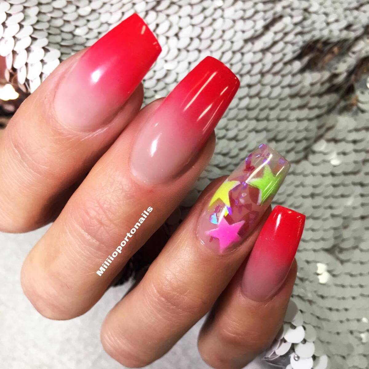 16. Bold Red Ombré with Starry Accents