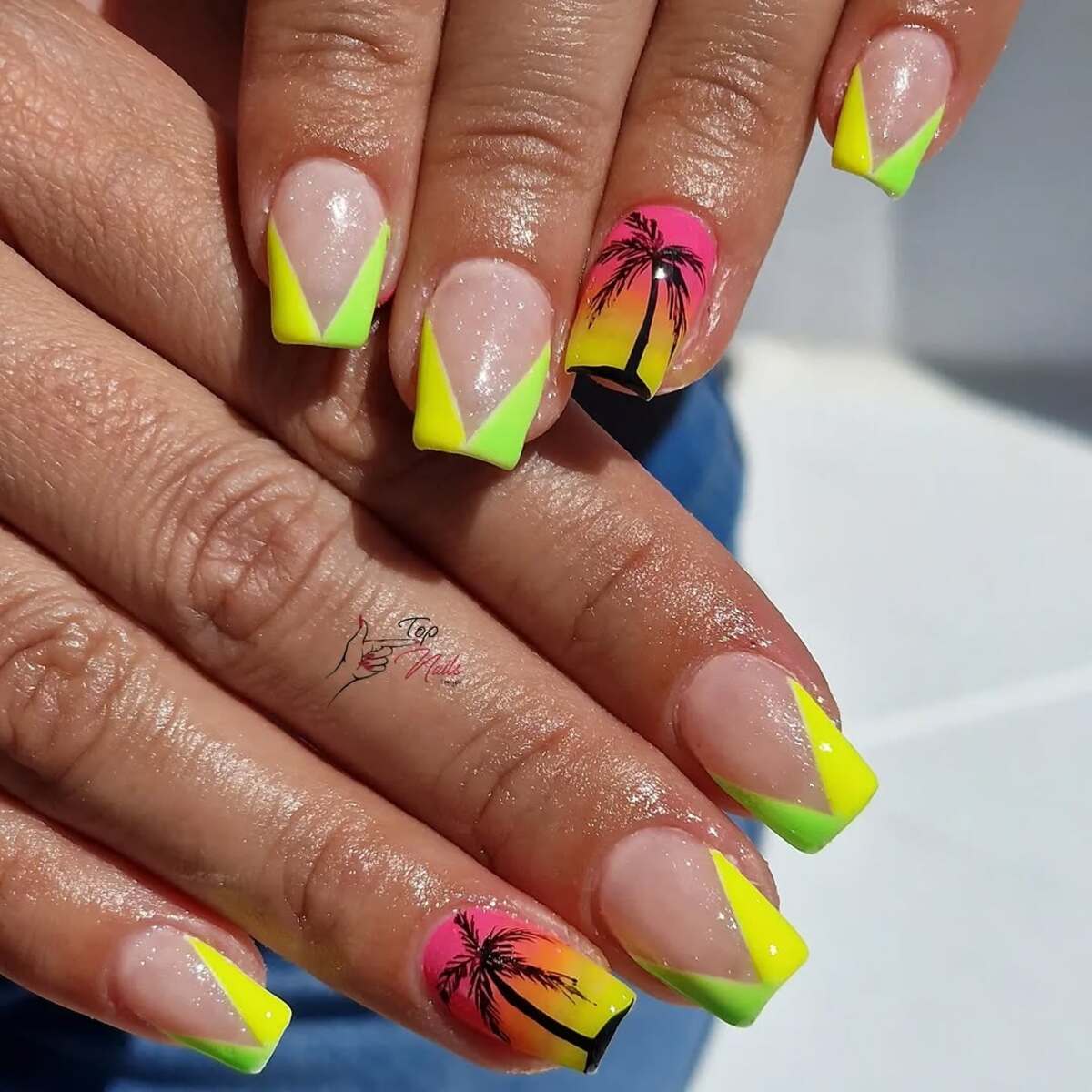 7. Neon French Tips with a Palm Tree Accent
