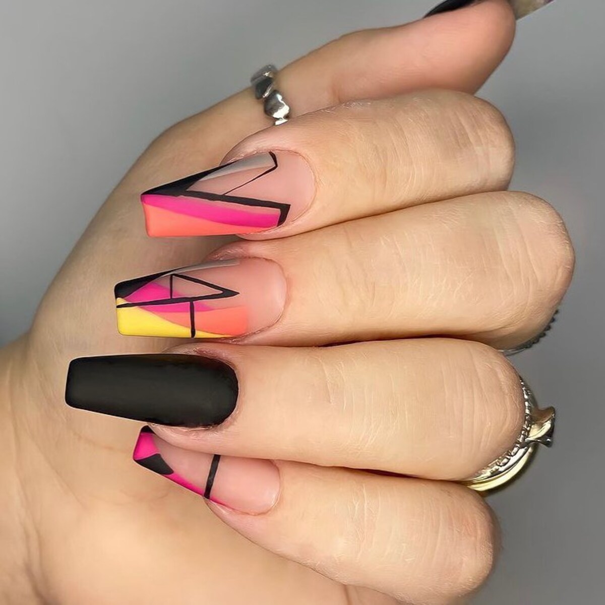 1. Bold Neon and Black Geometric Coffin Nails