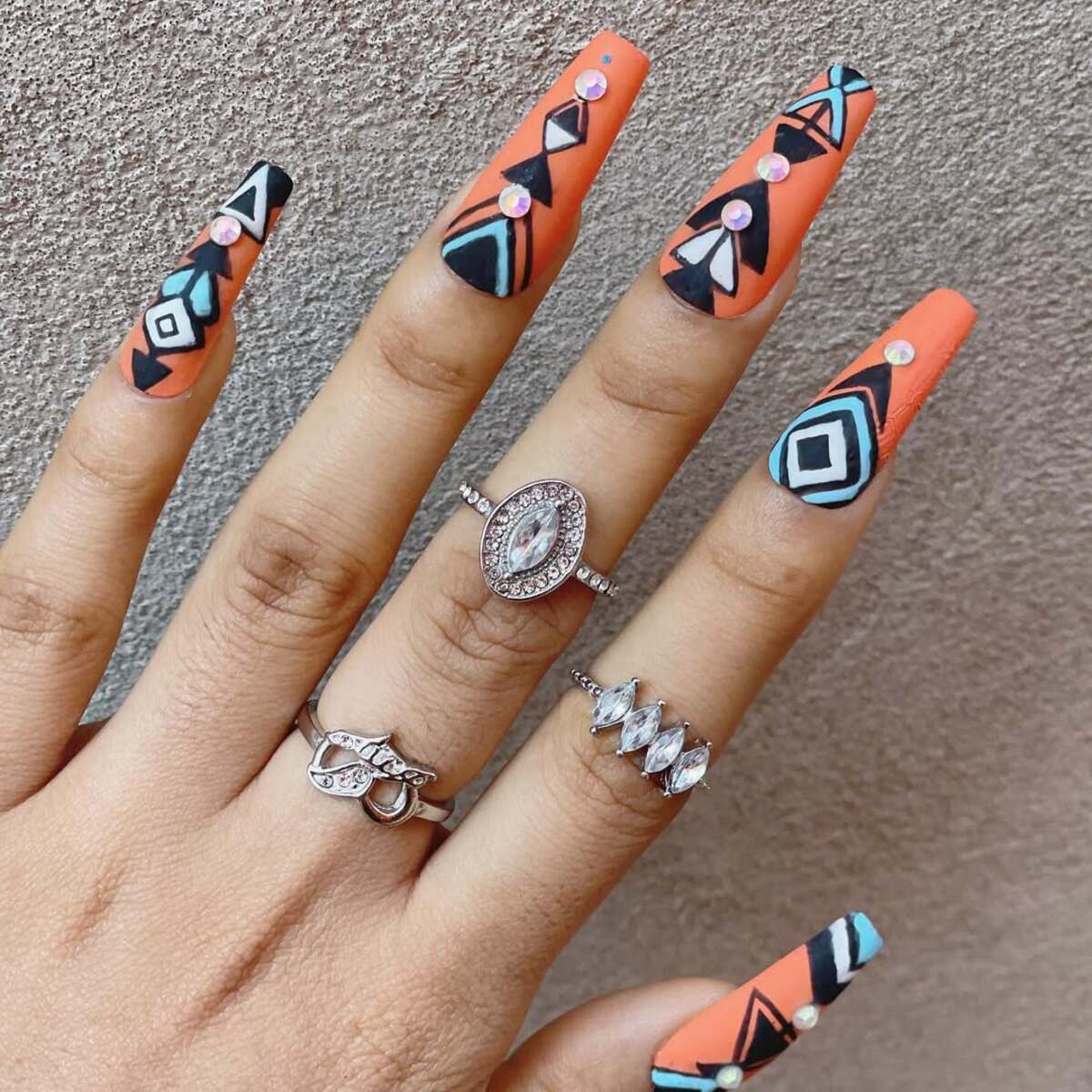 12. Tribal-Inspired Matte Neon Orange Nails