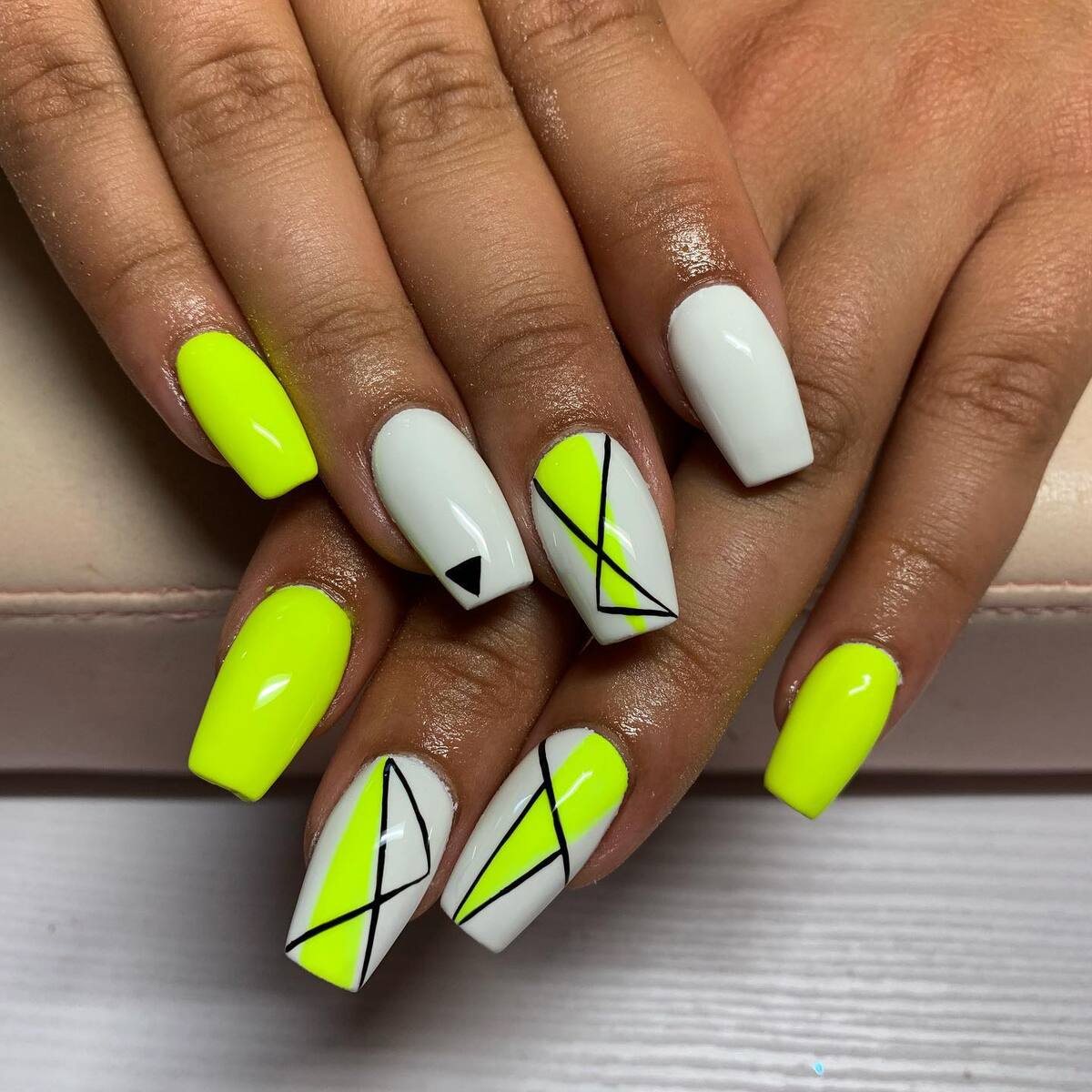 23. Bold Neon Yellow and White Geometric Nails