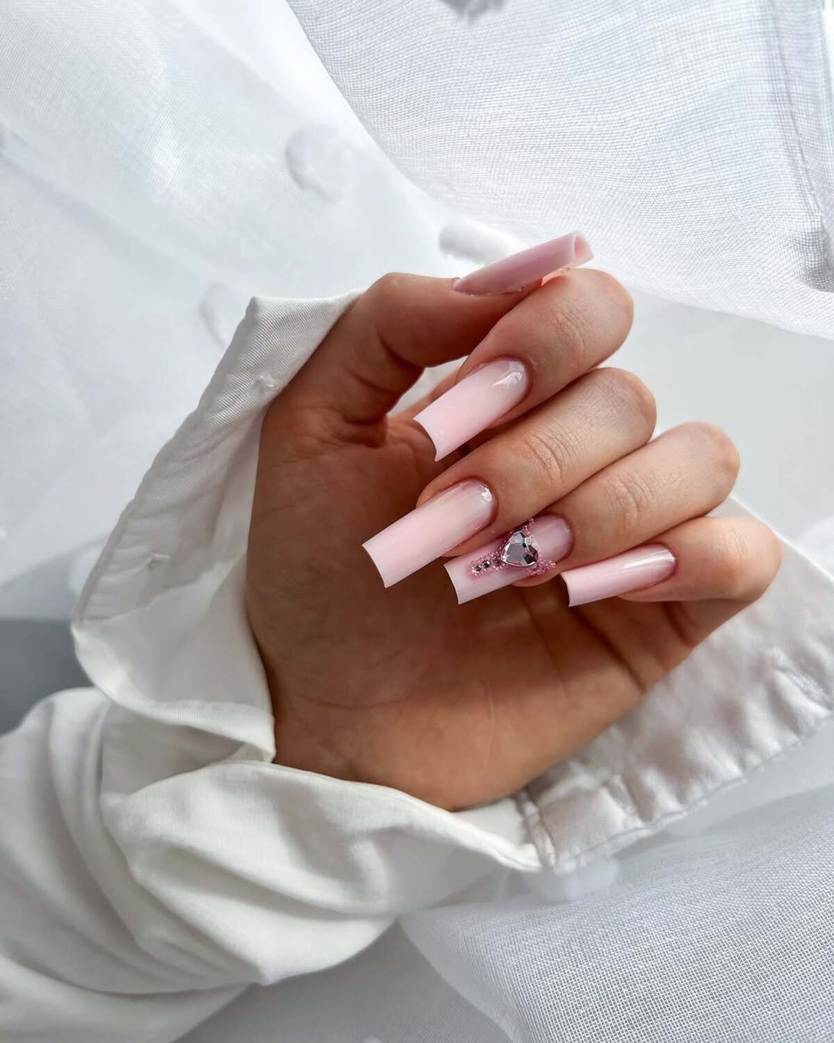 23. Elegant Pink Coffin Nails with a Statement Rhinestone