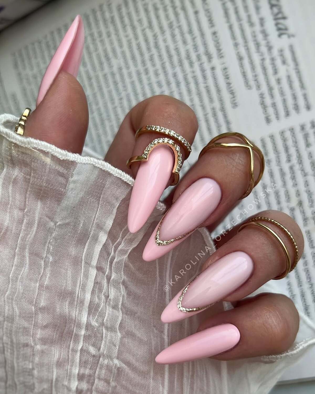 7. Soft Pink Almond Nails with Gold Embellishments