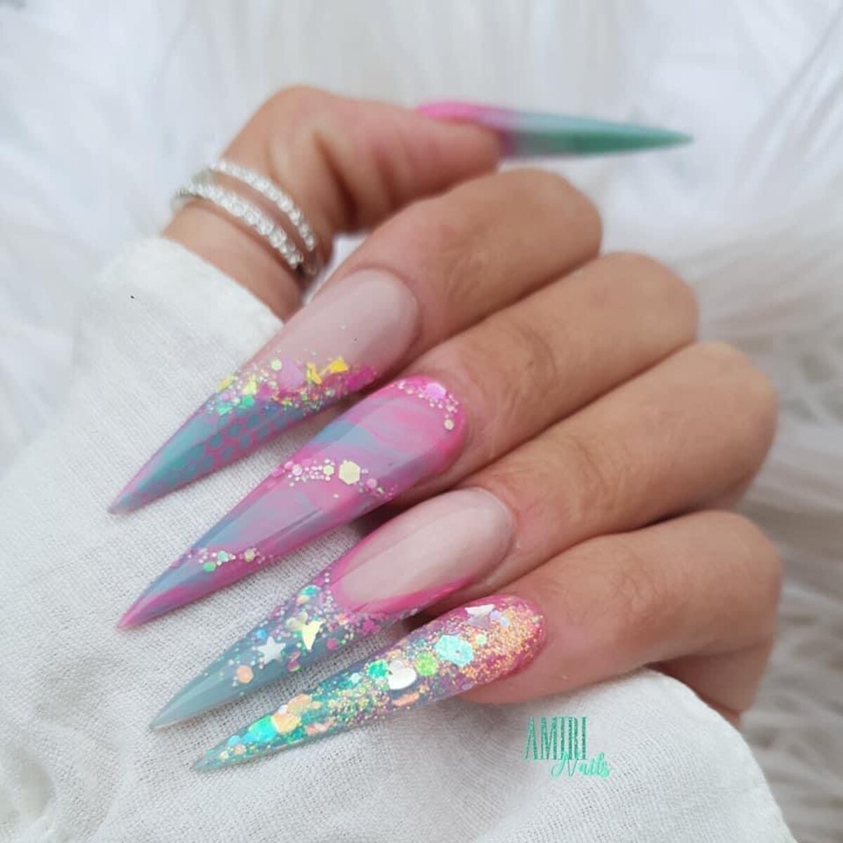 13. Ultra-Long Stiletto Nails with Pink and Aqua Marble Glitter