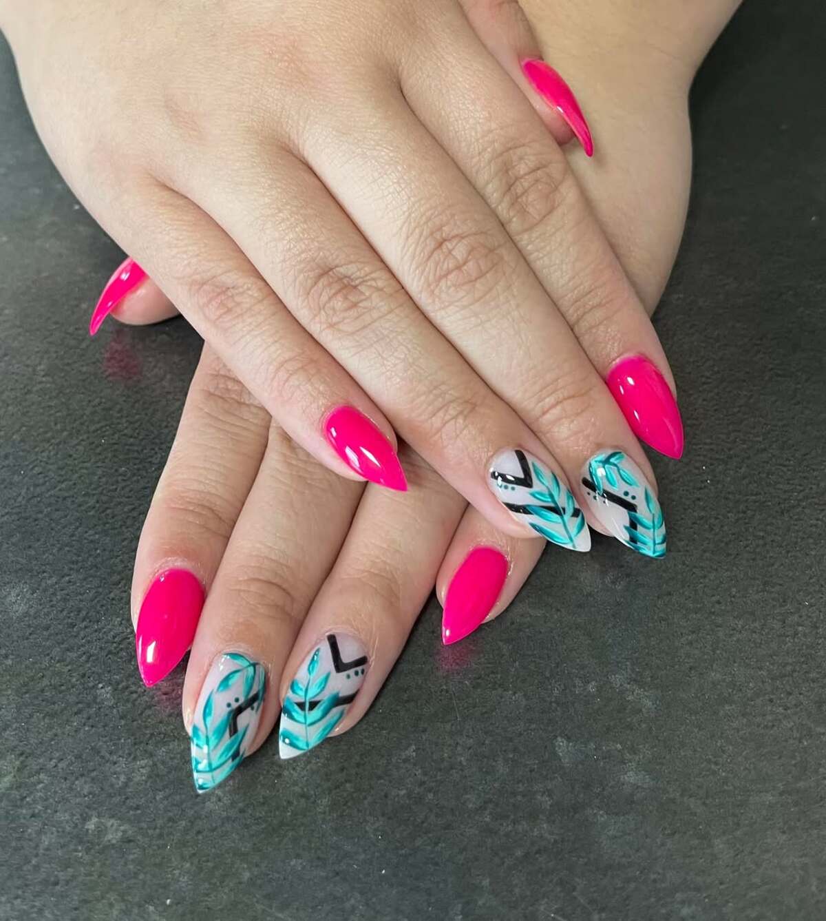 20. Vibrant Hot Pink Stiletto Nails with Tropical Leaf Art