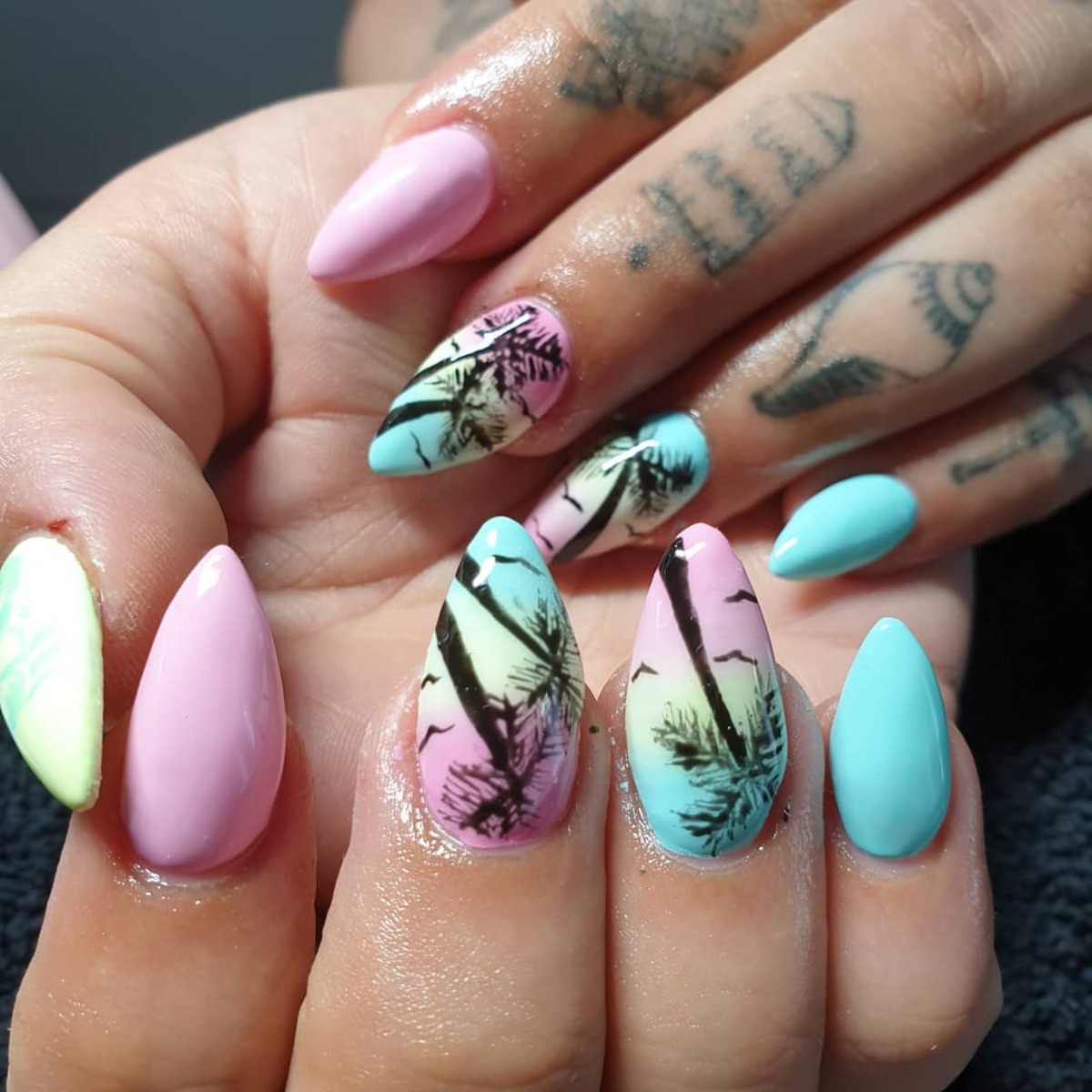 23. Tropical Sunset Stiletto Nails with Palm Tree Accents
