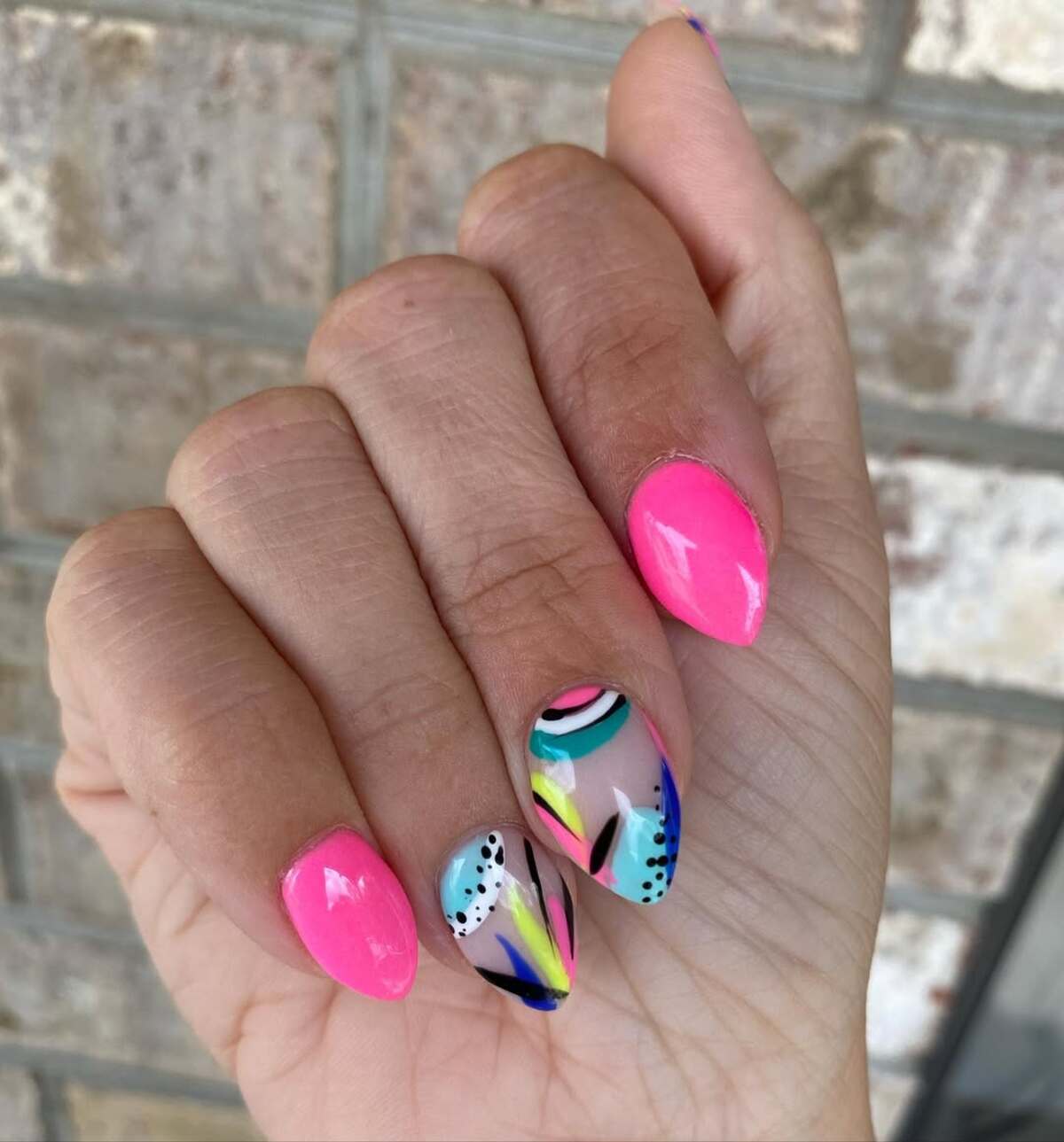 26. Bold Hot Pink and Aqua Stiletto Nails with Abstract Art
