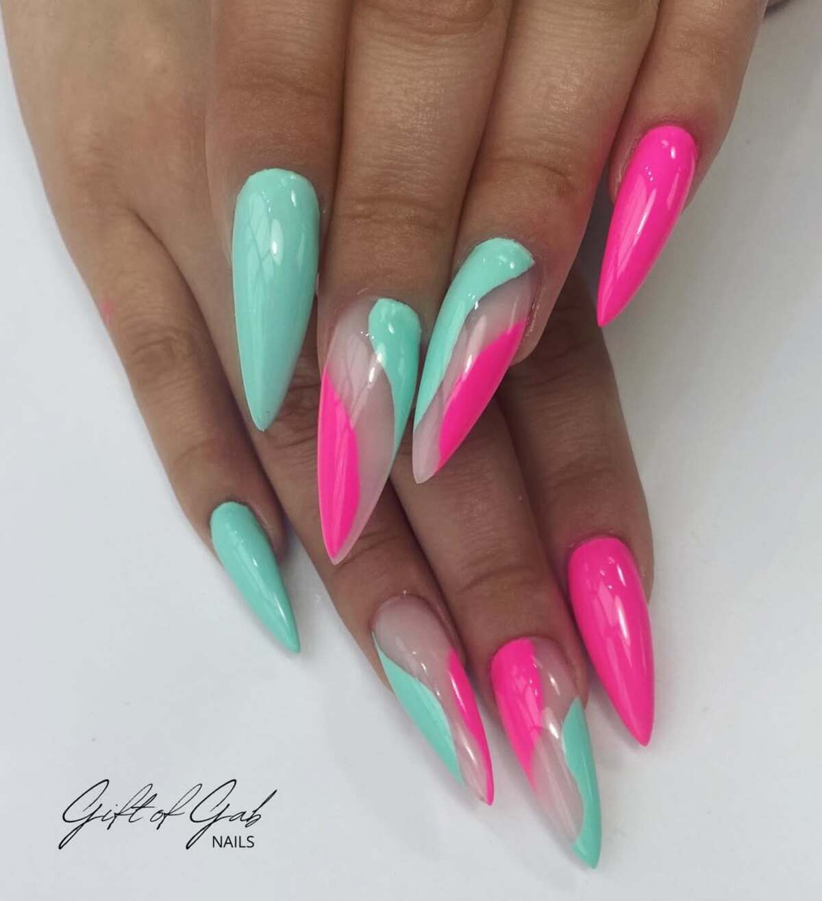 6. Sleek Hot Pink and Aqua Stiletto Nails with Negative Space