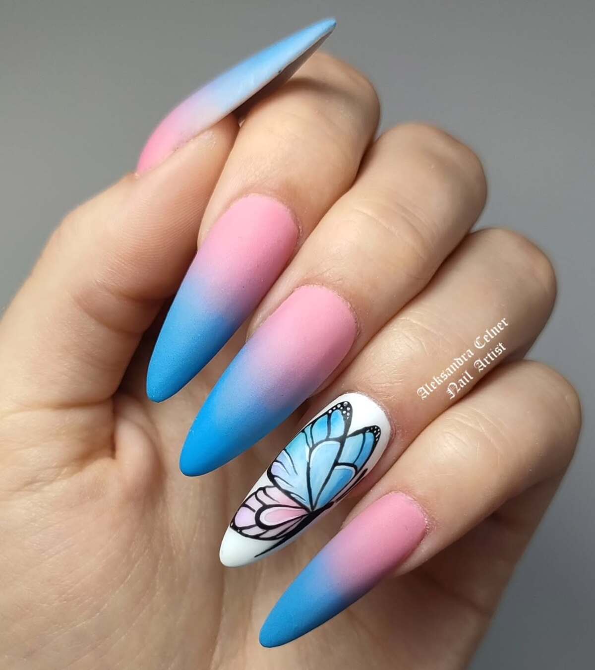 8. Soft Ombré Stiletto Nails with Delicate Butterfly Art