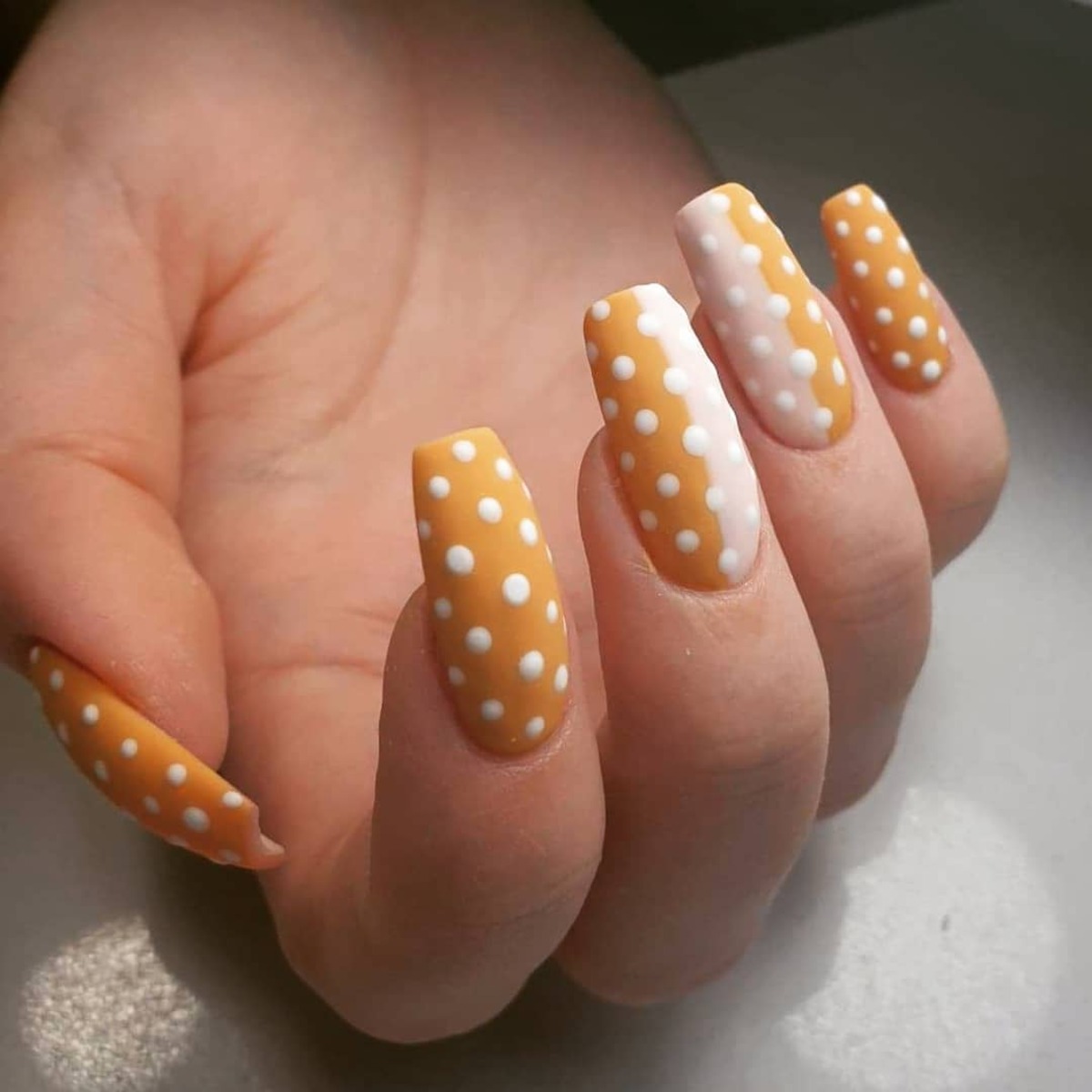 1. Playful Orange and White Polka Dot Nails