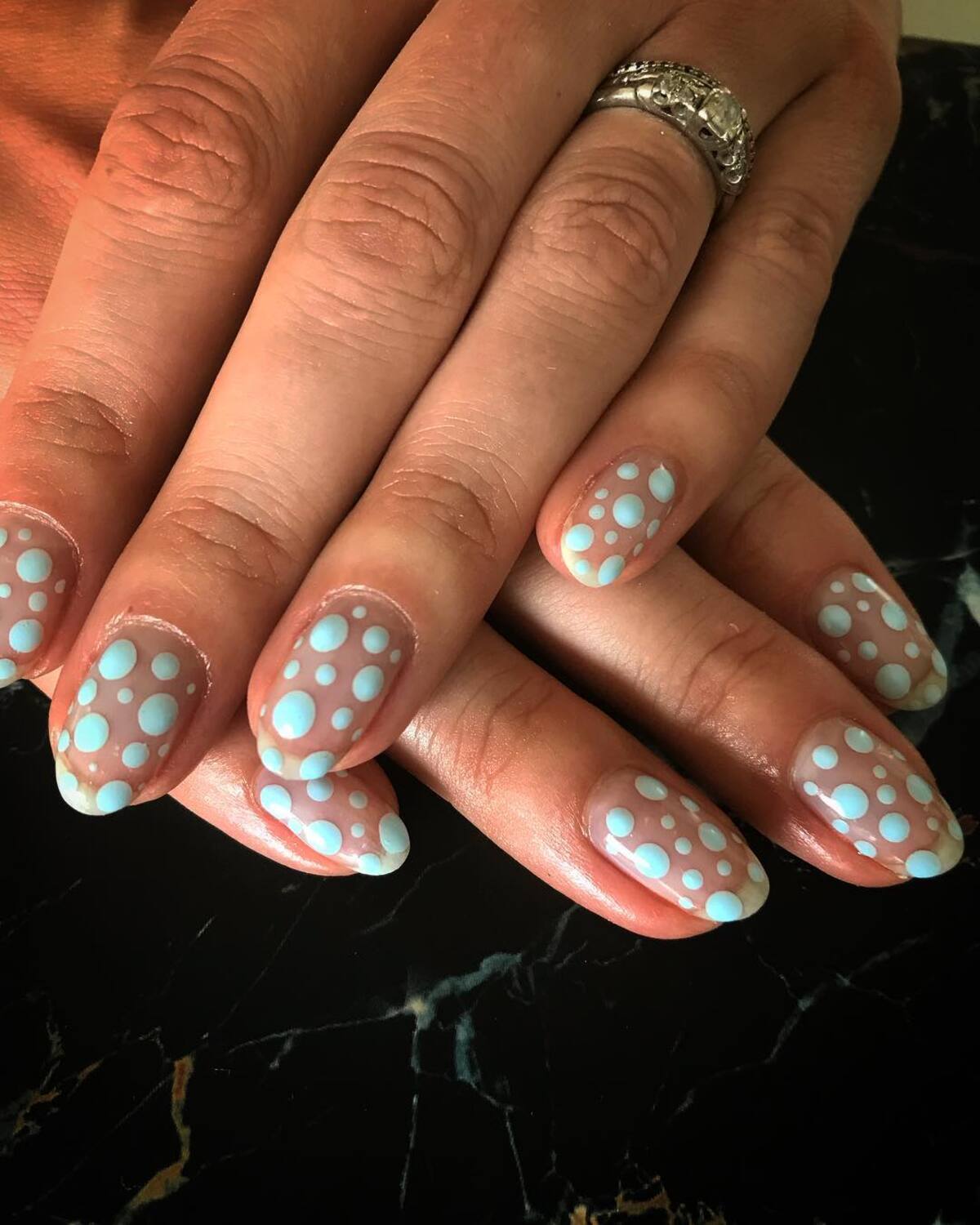 13. Sheer Nude Nails with Oversized Blue Polka Dots