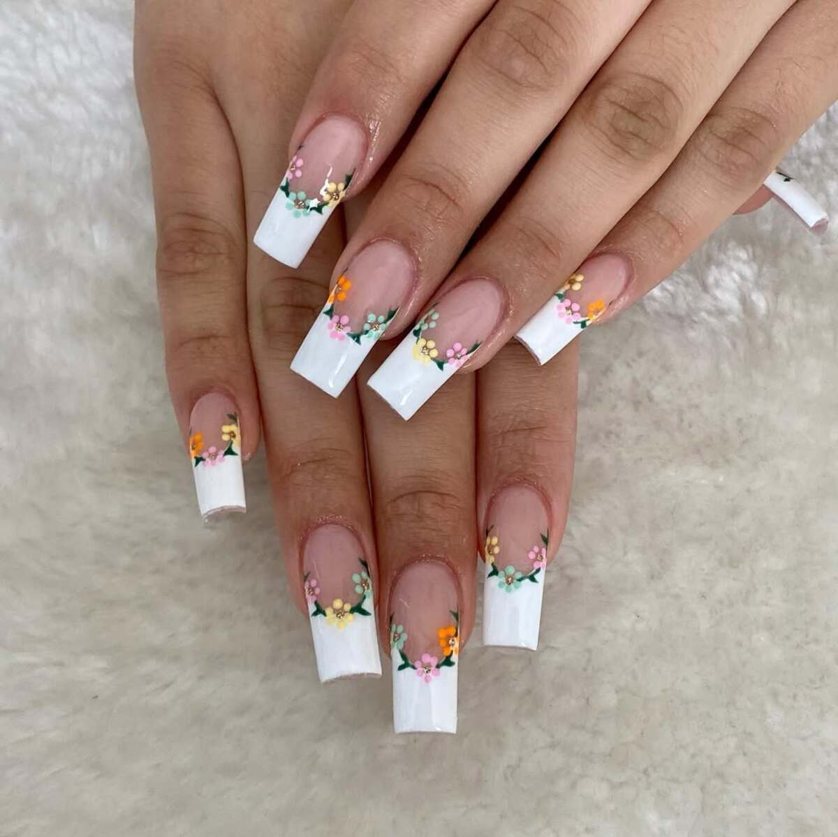 15. Floral French Tips with Delicate Blooms