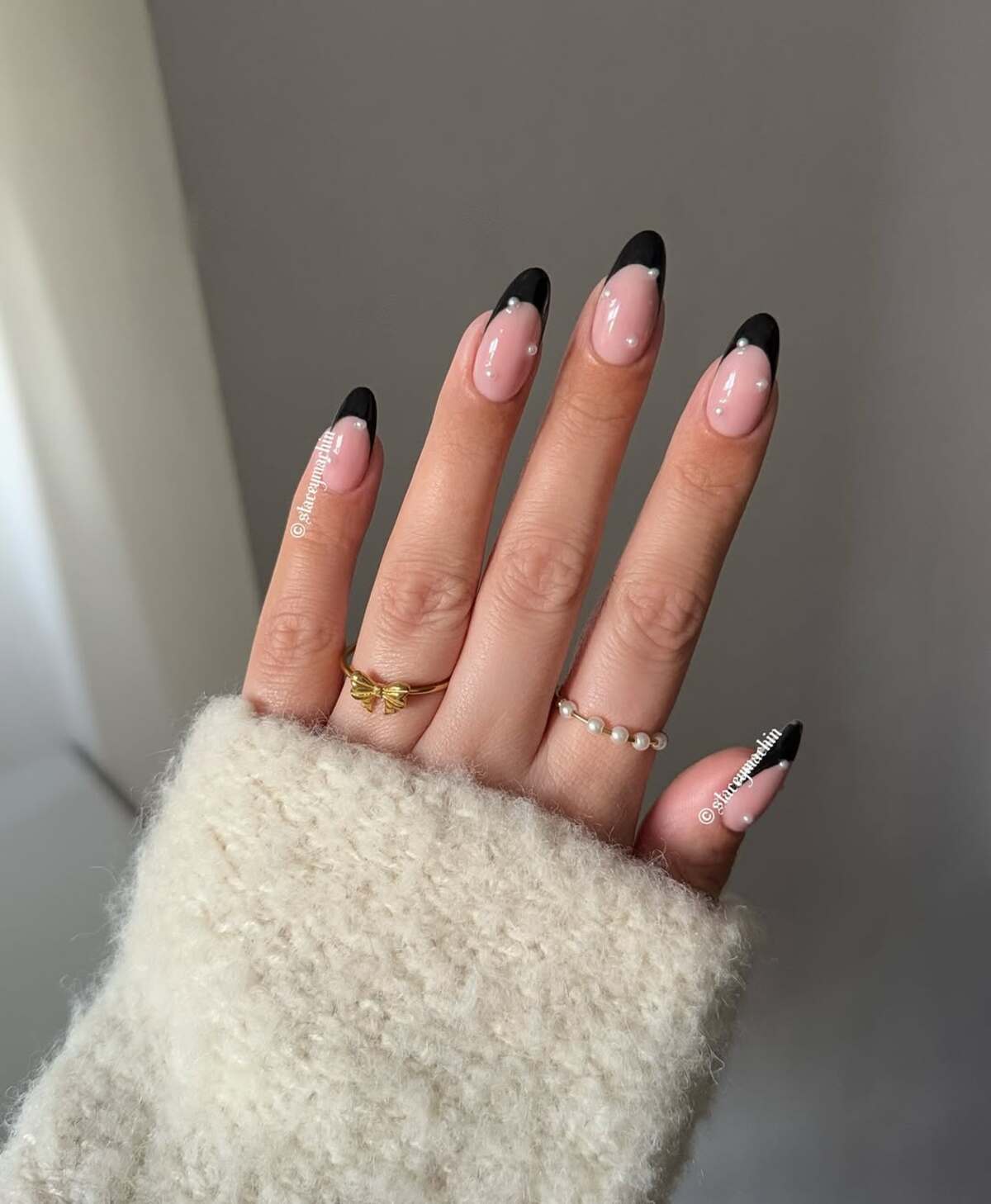 2. Chic Black French Tips with Pearl Accents