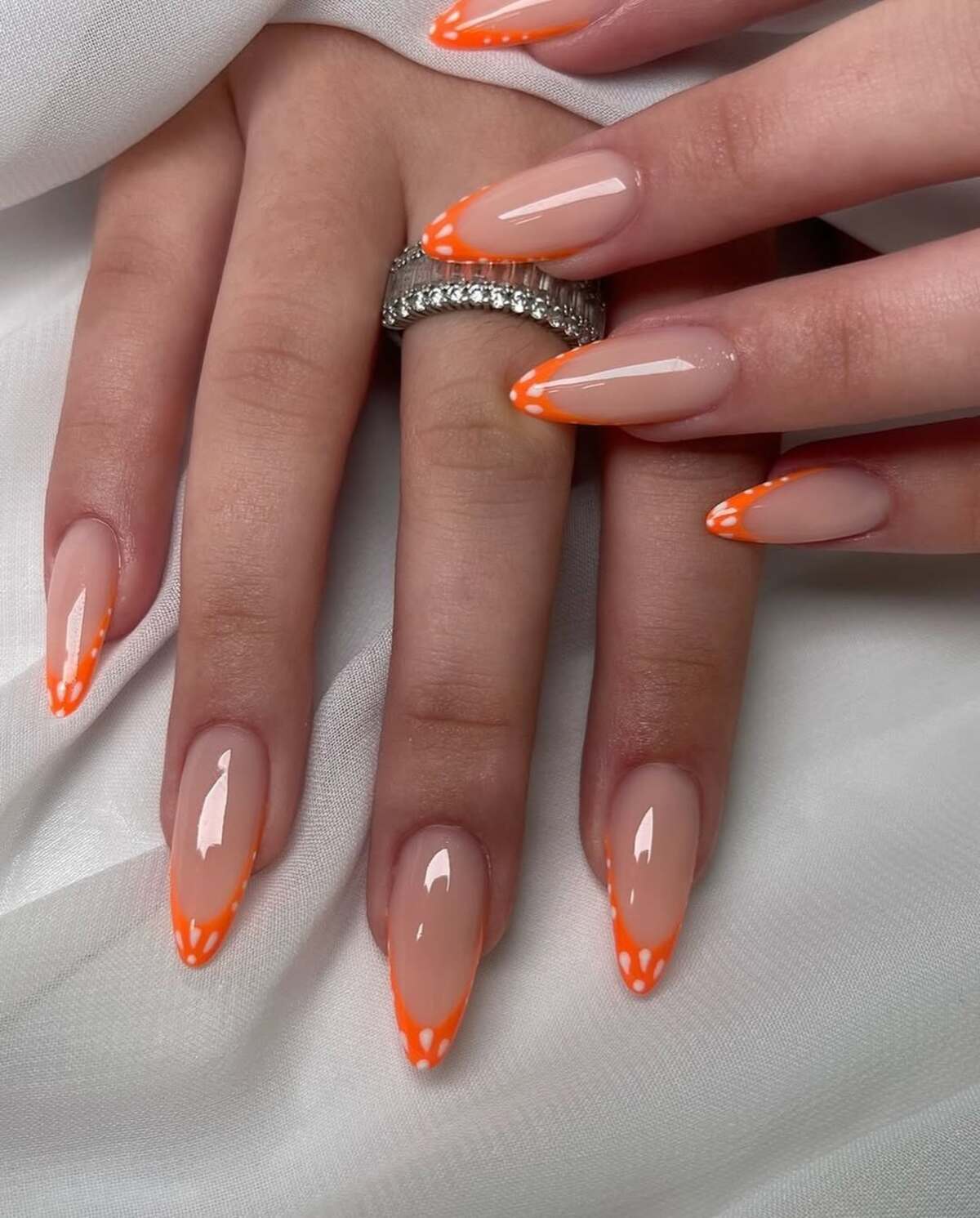 21. Playful Orange French Tips with Polka Dots