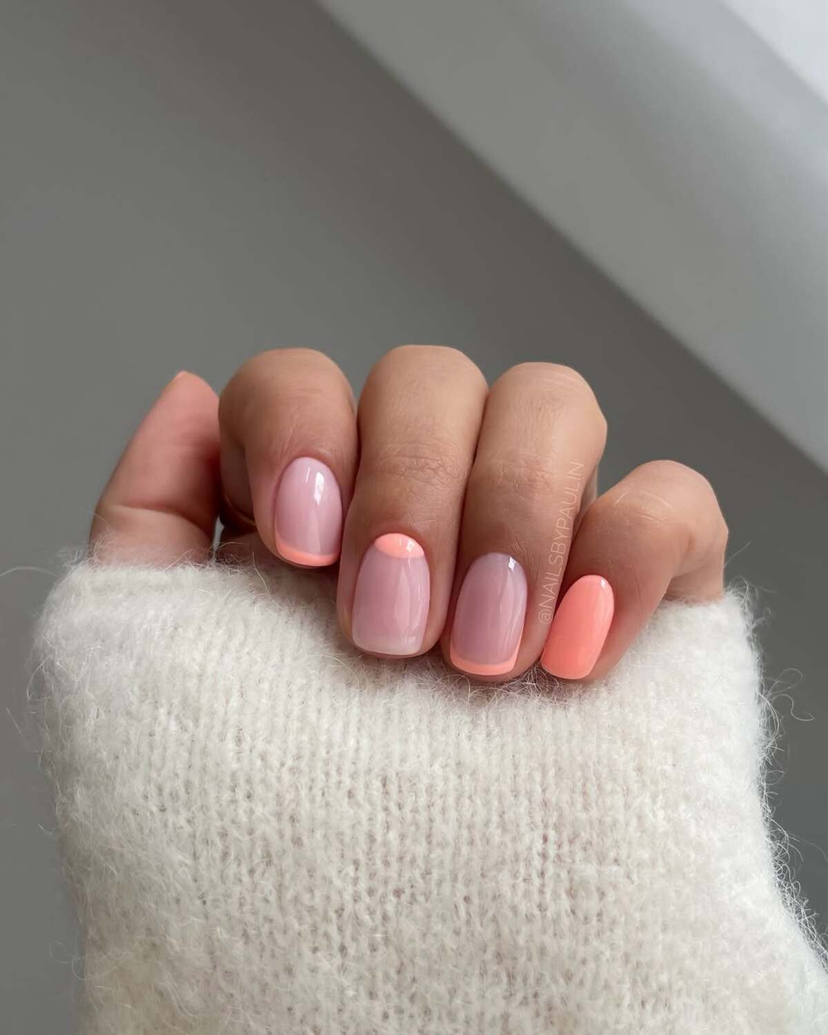 28. Pastel Coral French Tips for a Soft Feminine Touch
