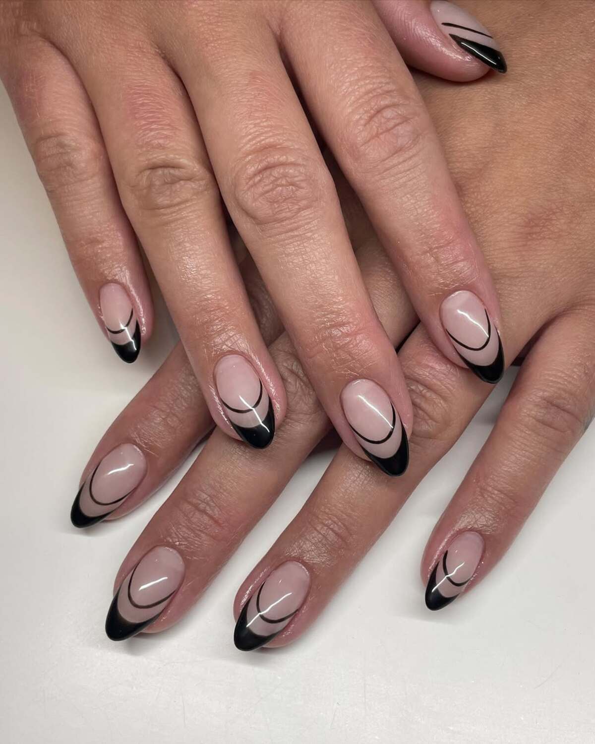 9. Sleek Black French Tips with Abstract Curves