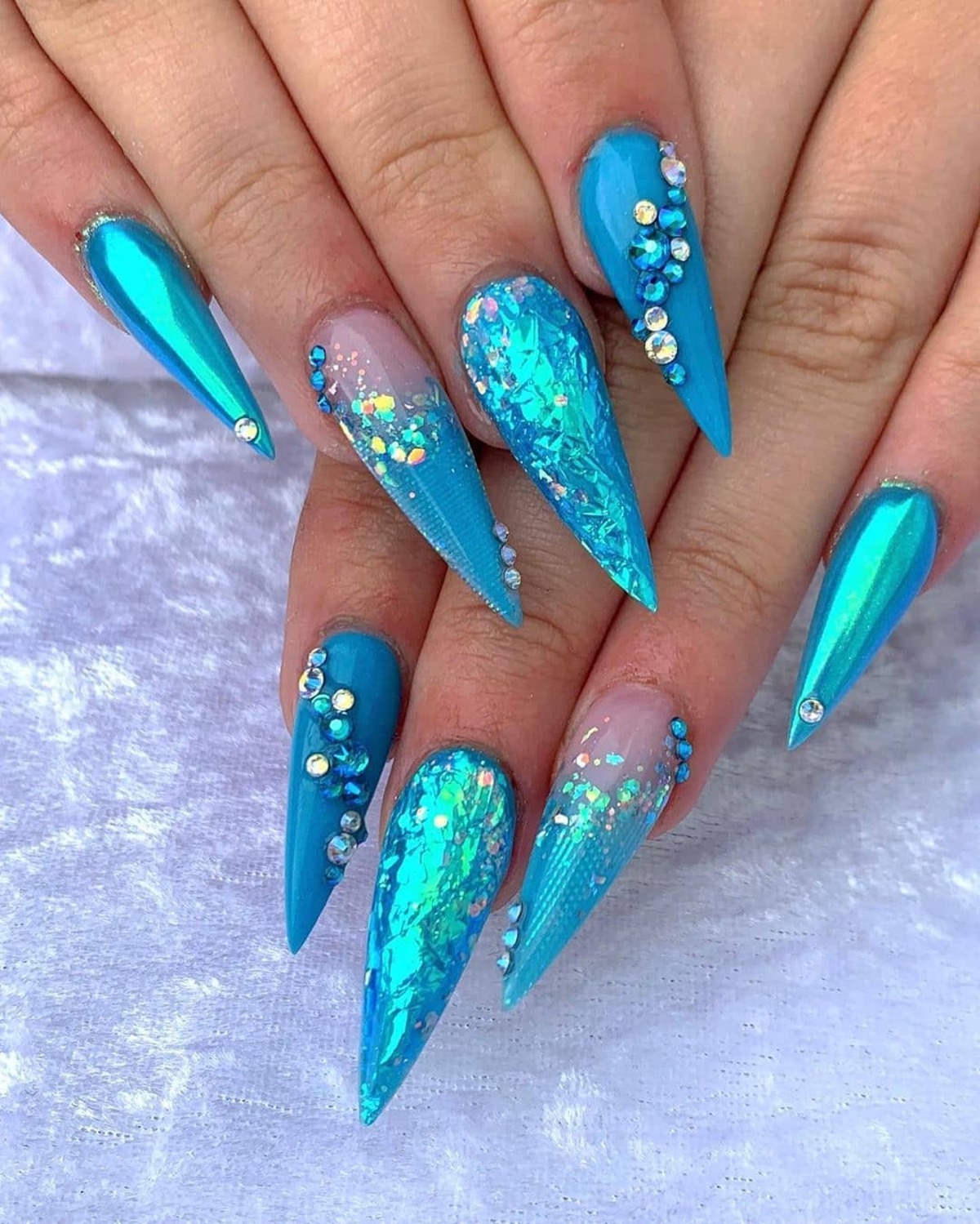 26. Ocean Blue Stiletto Nails with Holographic Shimmer