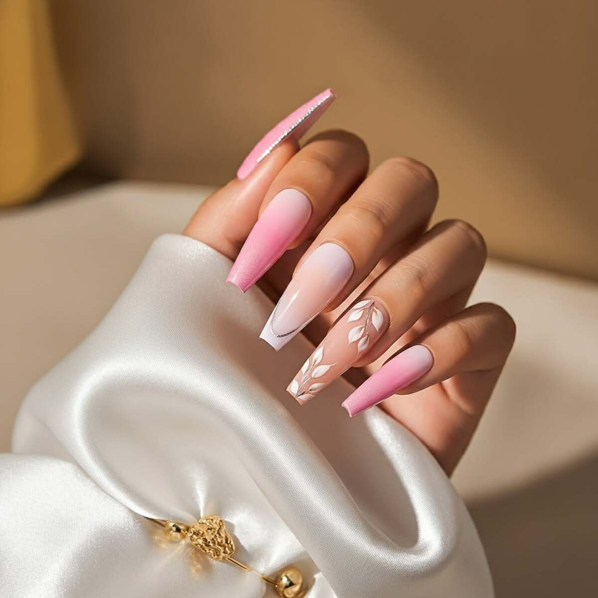 16. Elegant Pink Ombre Nails with Leaf Designs