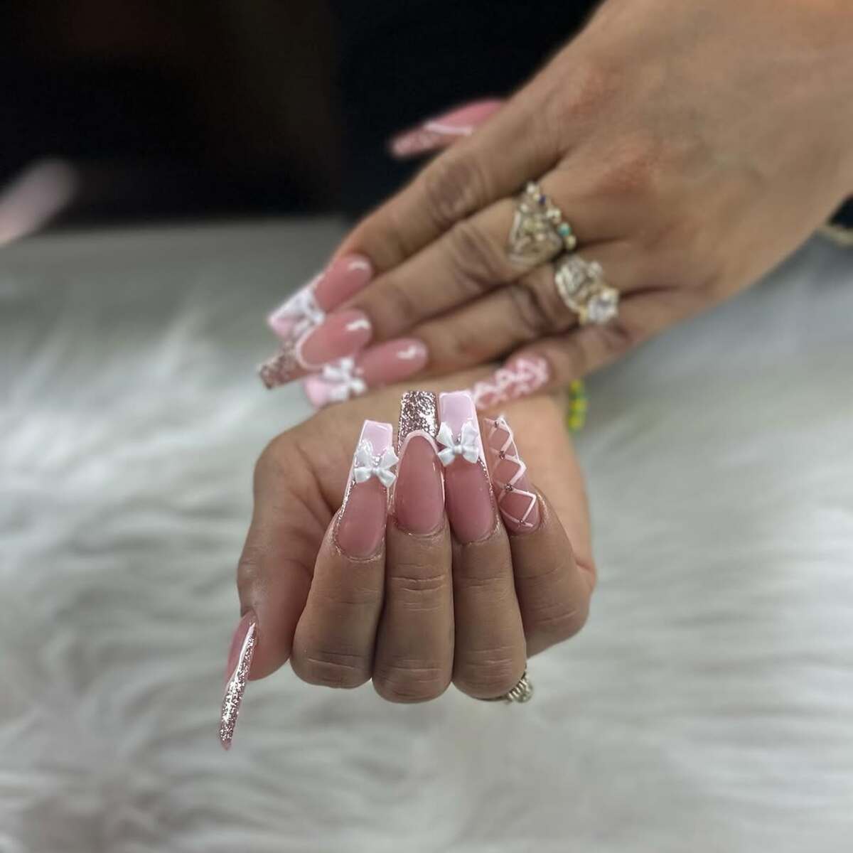 18. Romantic Pink Nails with Bows and Glitter