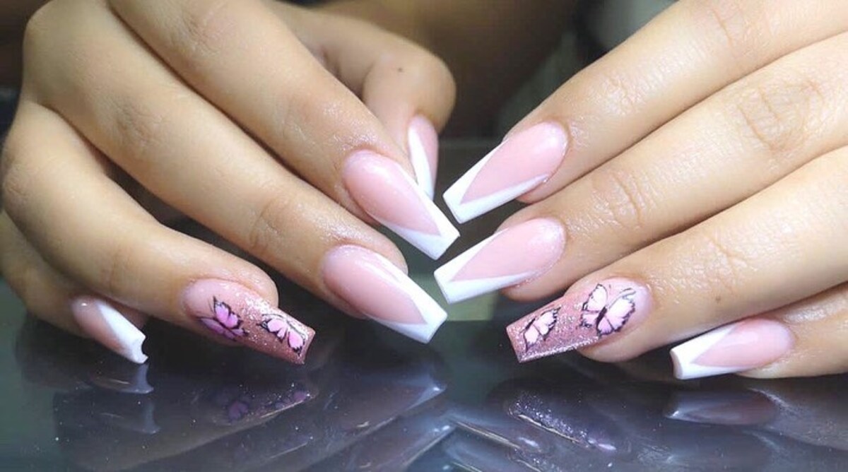 25. Classic White French Tips with Pink Butterfly Accents