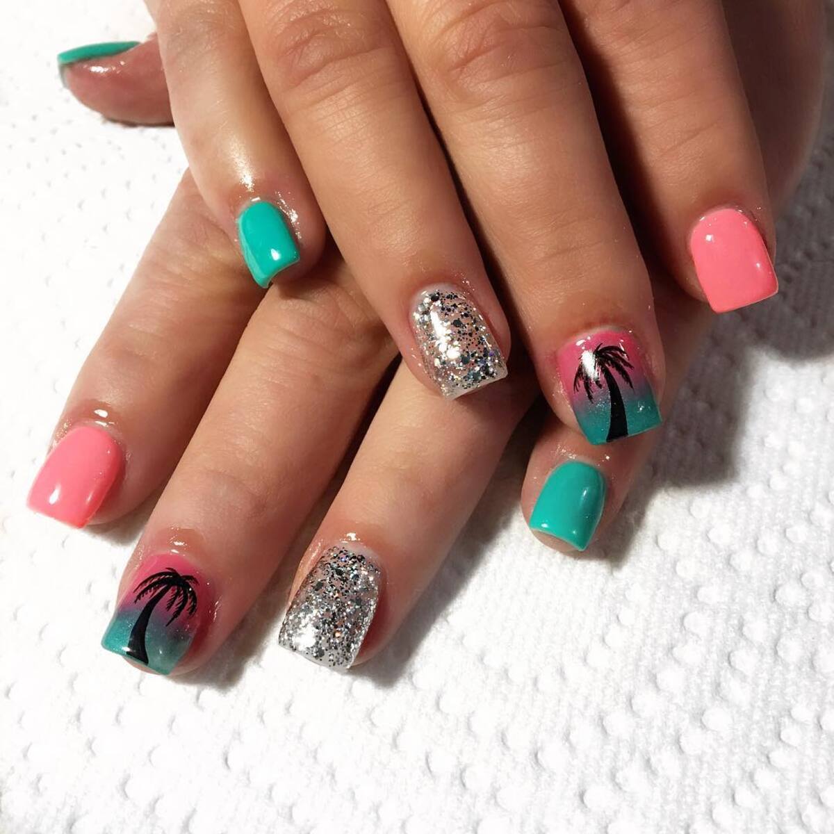 13. Tropical Sunset Gel Nails with Palm Tree Accents