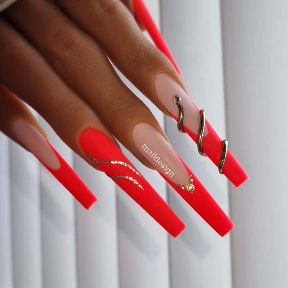 10. Fiery Red Glam with Gold Accents