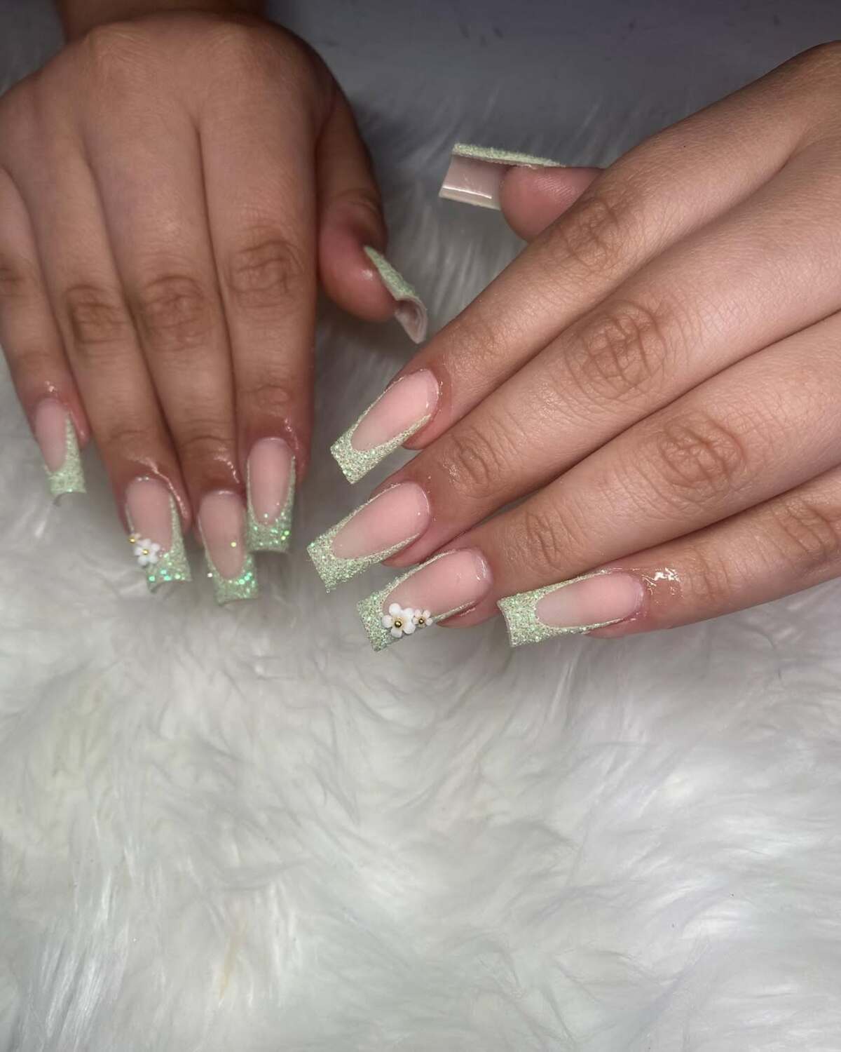 11. Sage Green Glitter French Tips with Floral Accents
