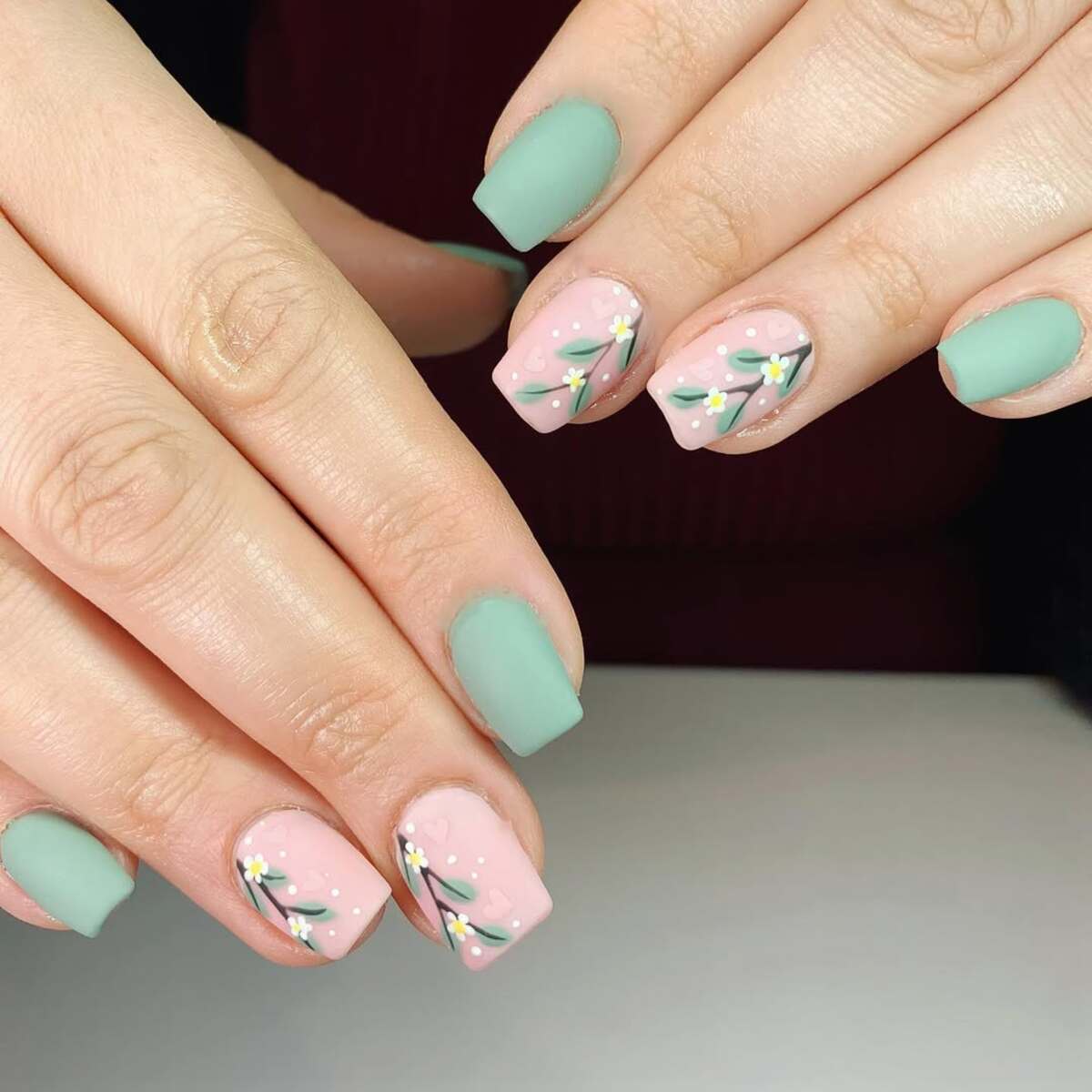17. Soft Green and Nude Floral Nail Design