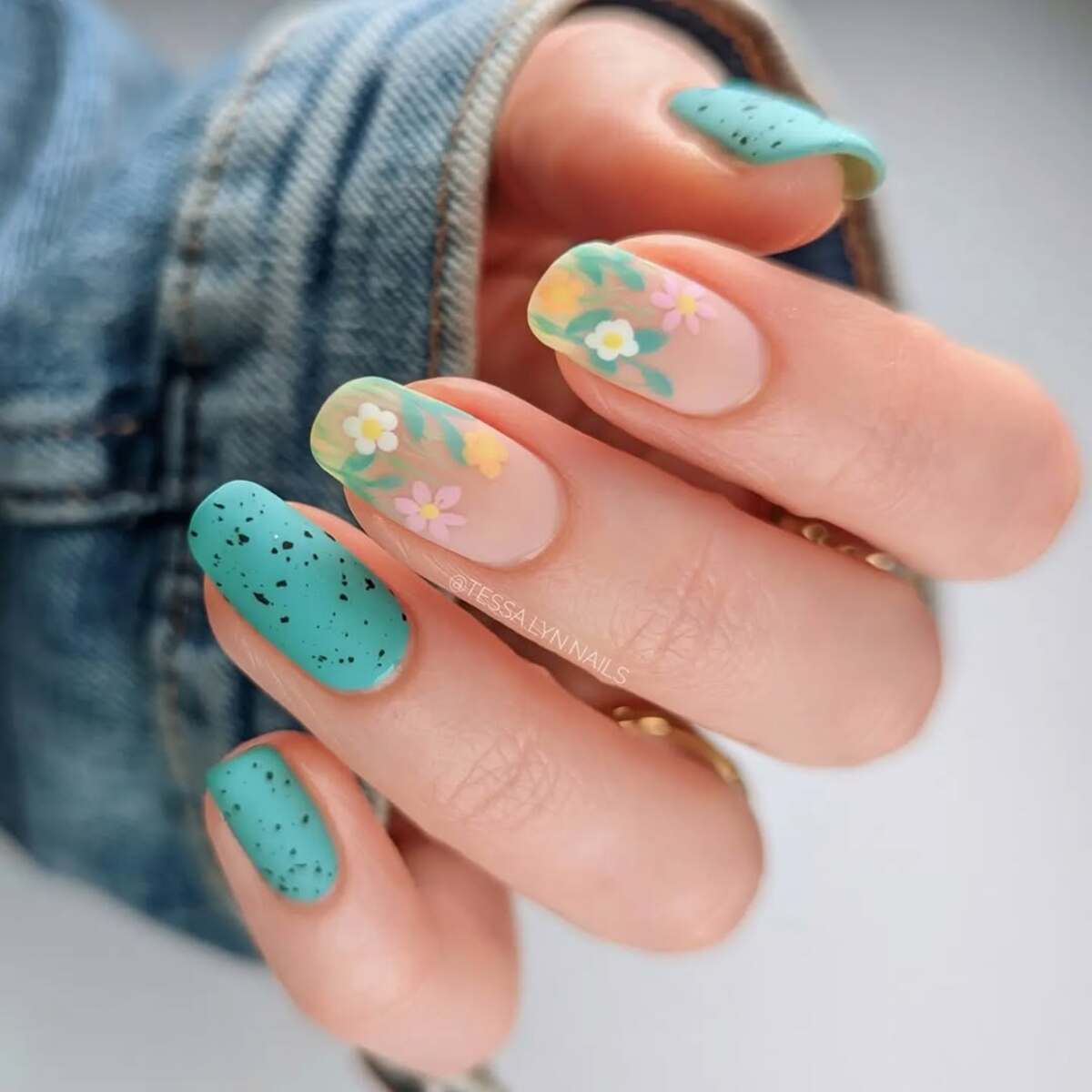 7. Playful Green Speckled Nails with Pastel Florals