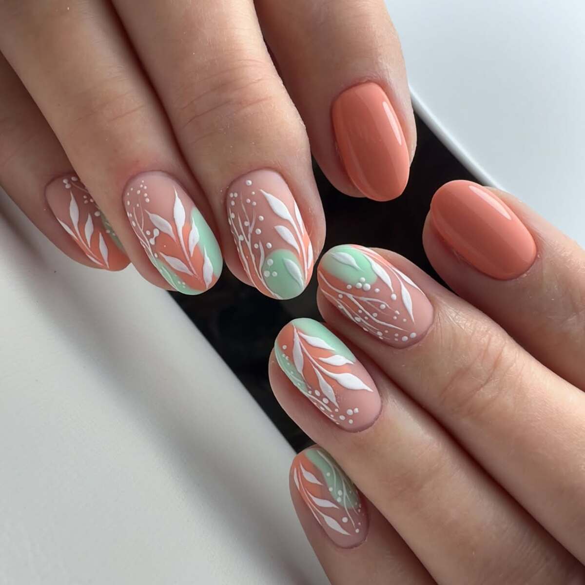 9. Soft Coral and Sage Green Botanical Nails
