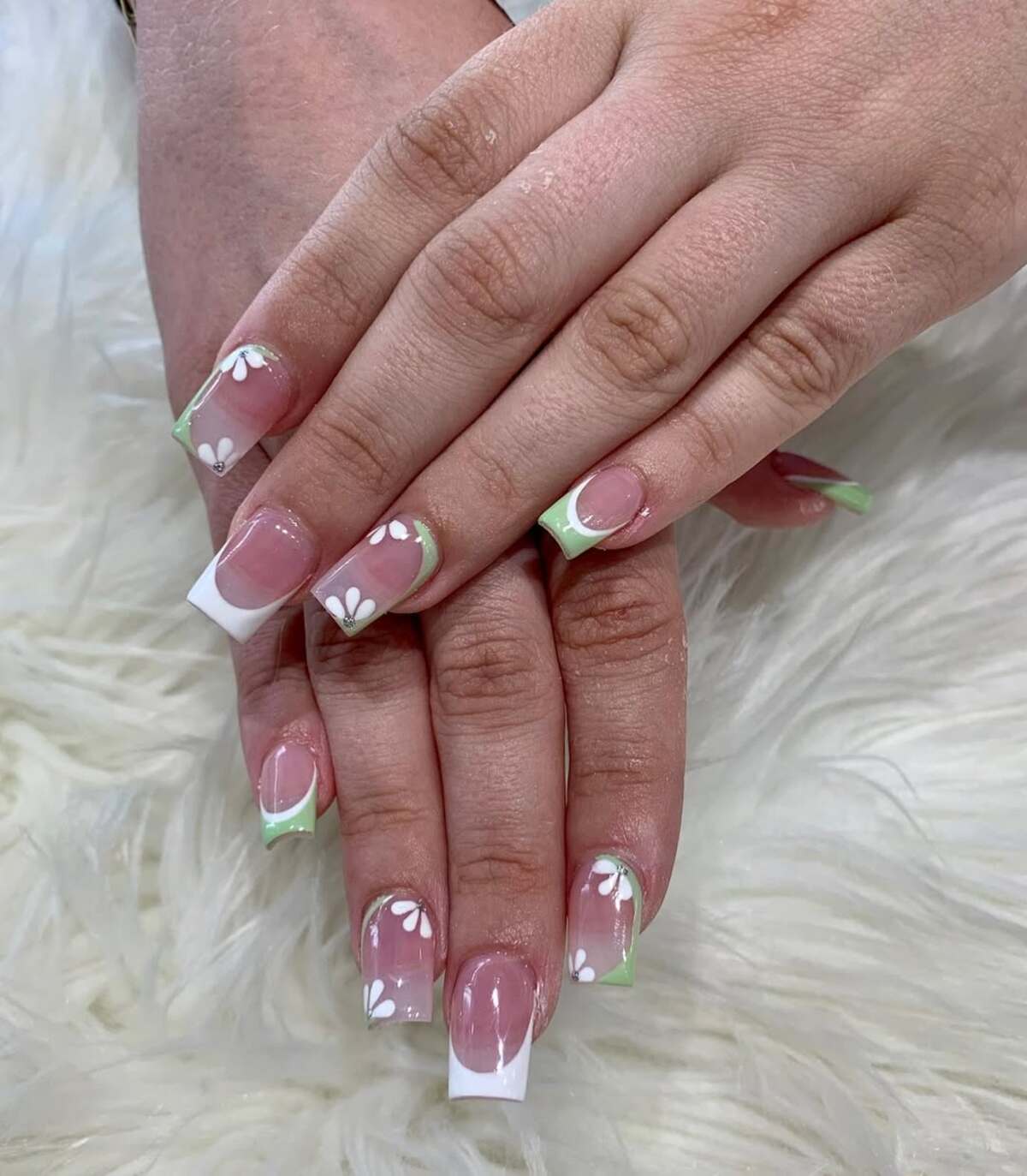 1. Soft Green French Tips with Delicate Daisies