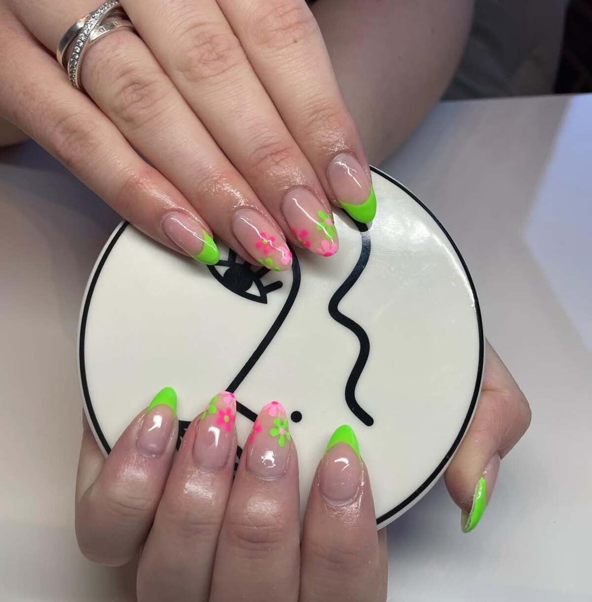 19. Neon Green French Tips with Floral Art