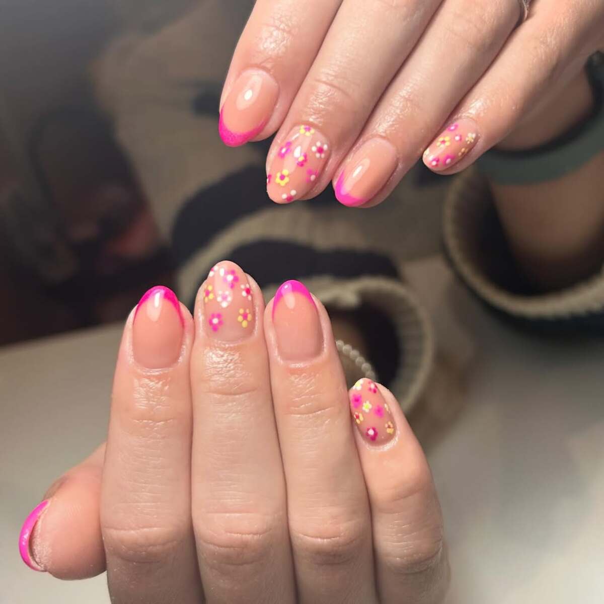 2. Playful Pink French Tips with Floral Accents