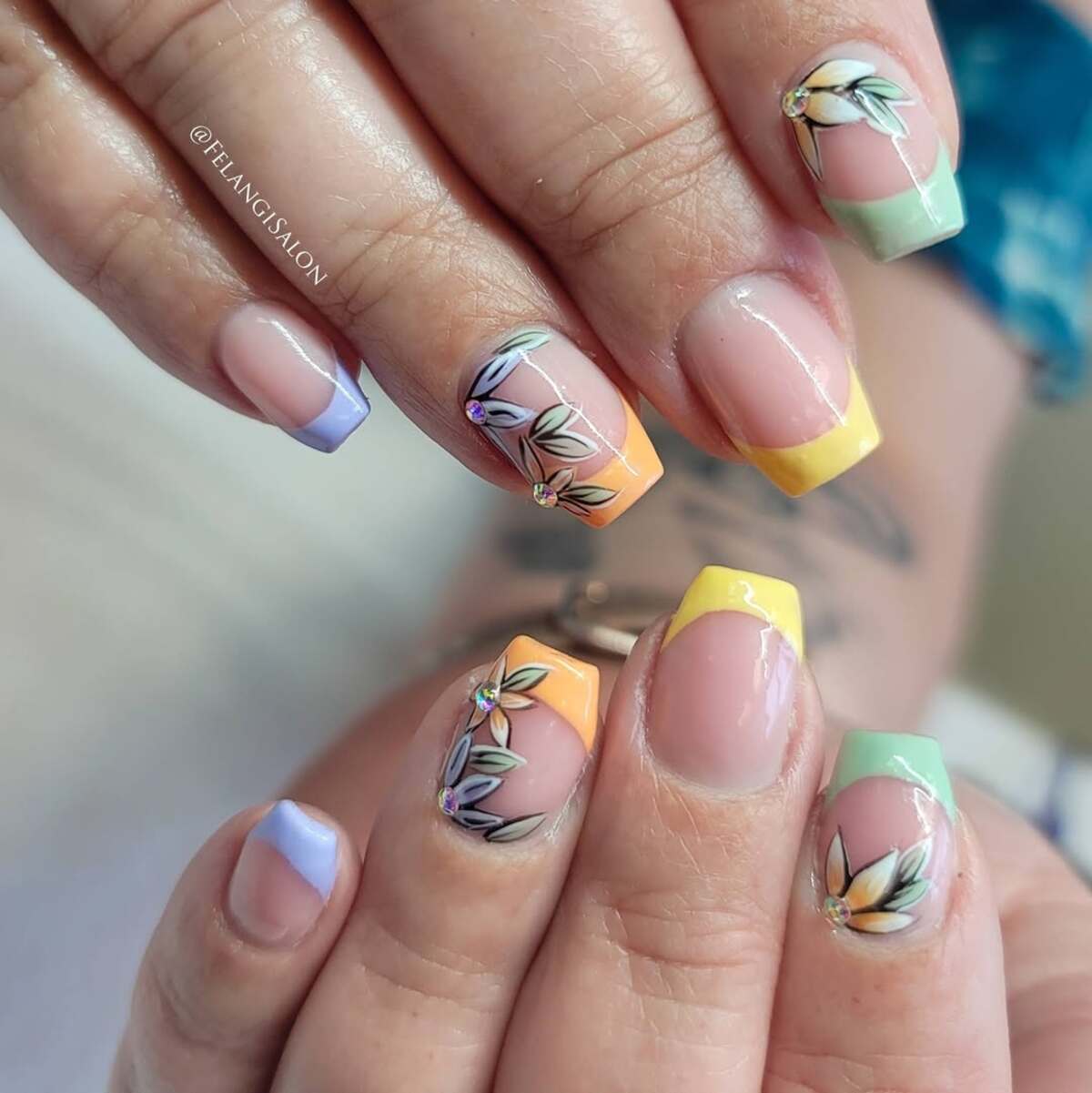 20. Pastel Rainbow French Tips with Floral Details