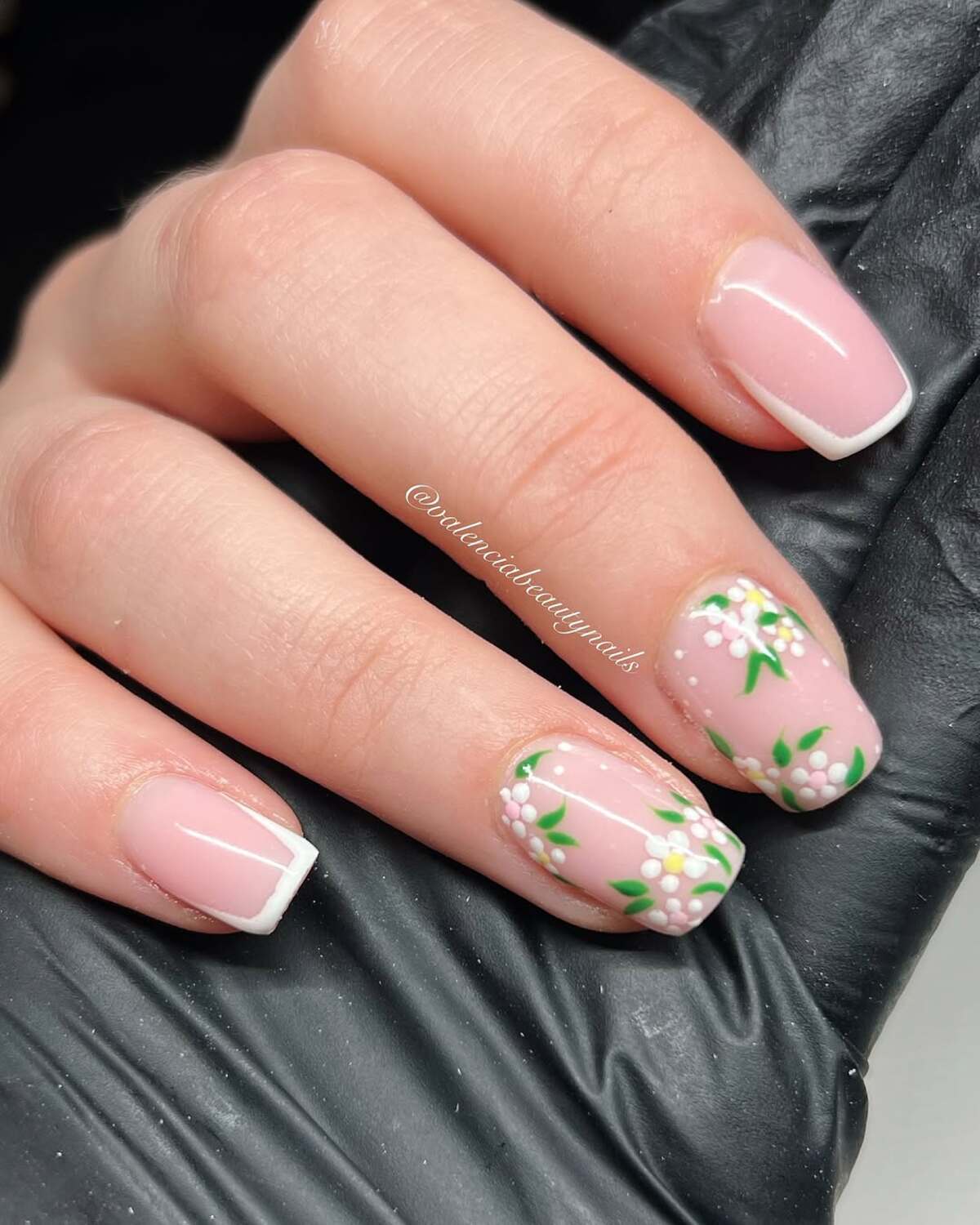 3. Classic French Tips with Floral Embellishments