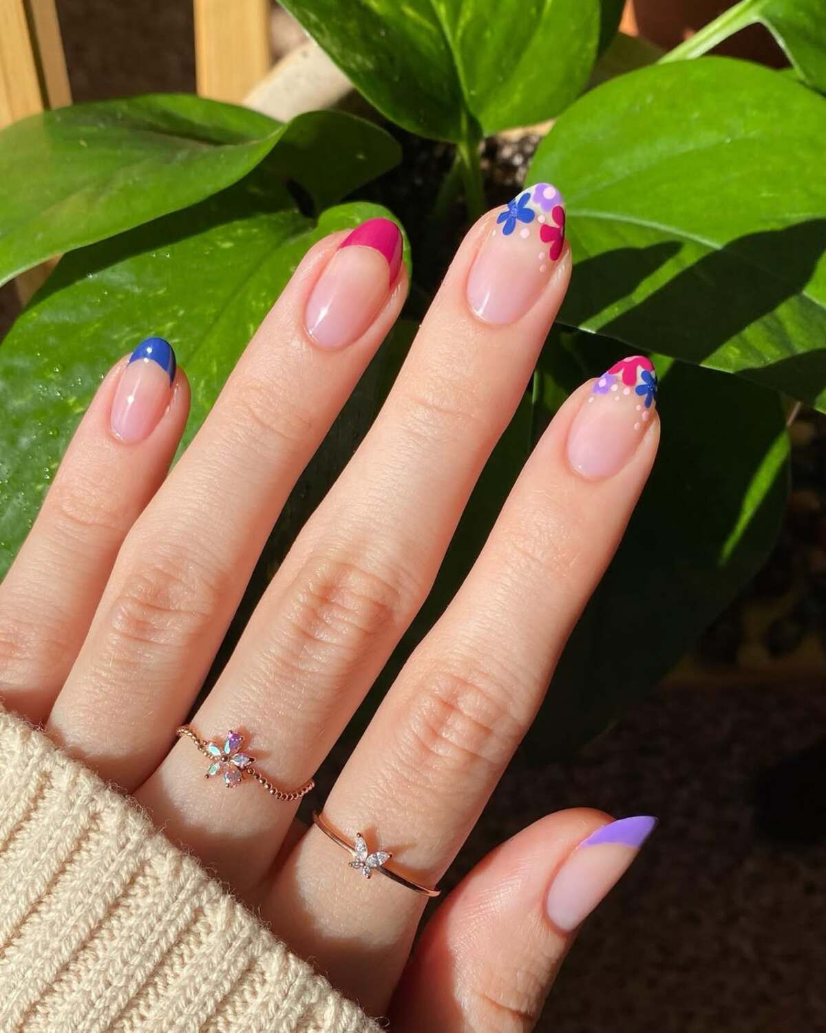 4. Colorful French Tips with Bold Floral Designs
