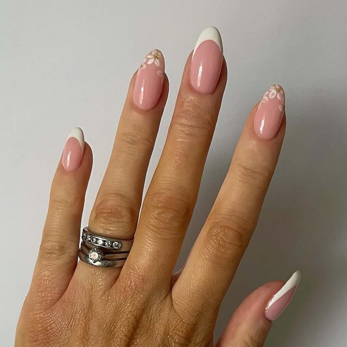 8. Elegant White French Tips with Gold Floral Touches