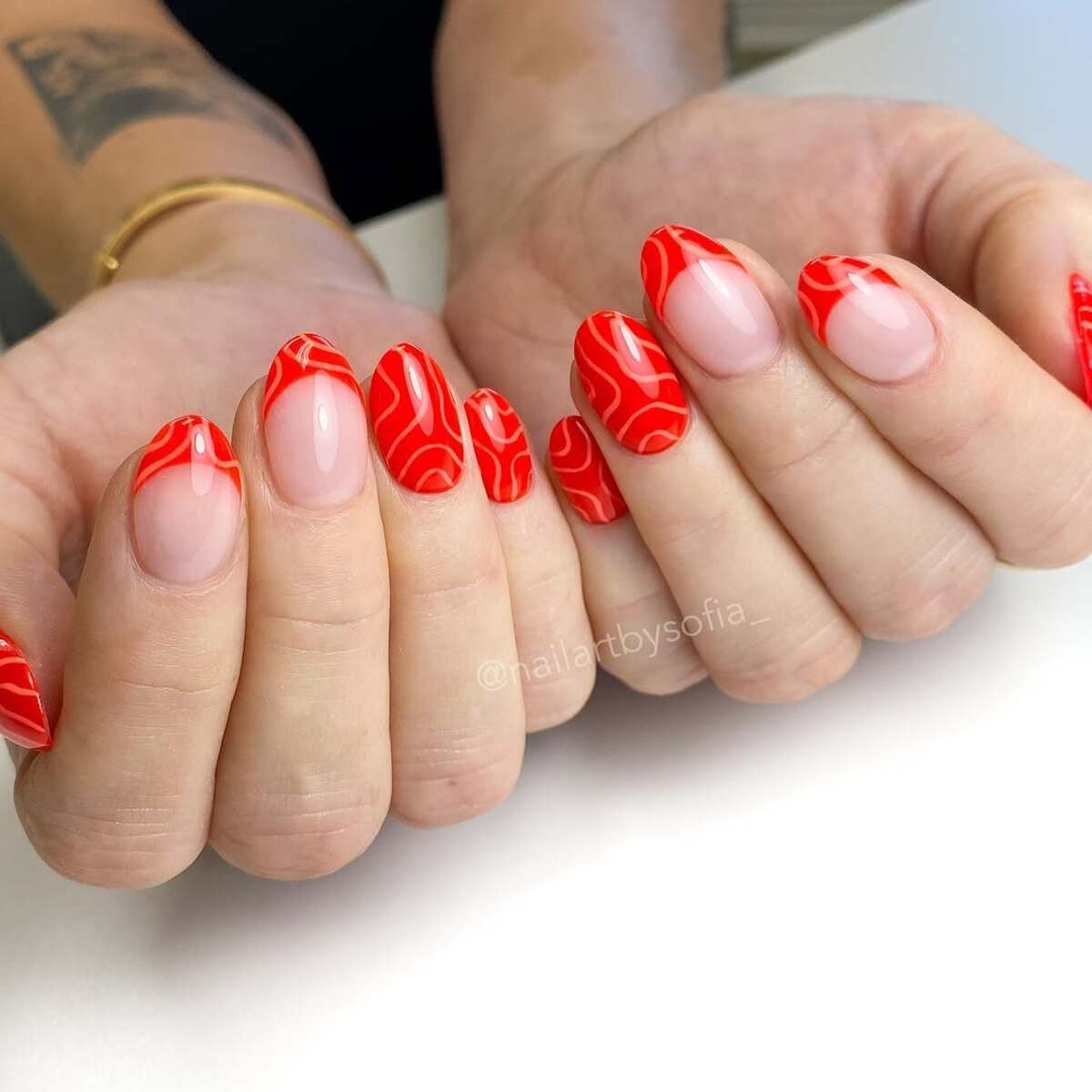 10. Swirled Red French Tips for a Modern Twist
