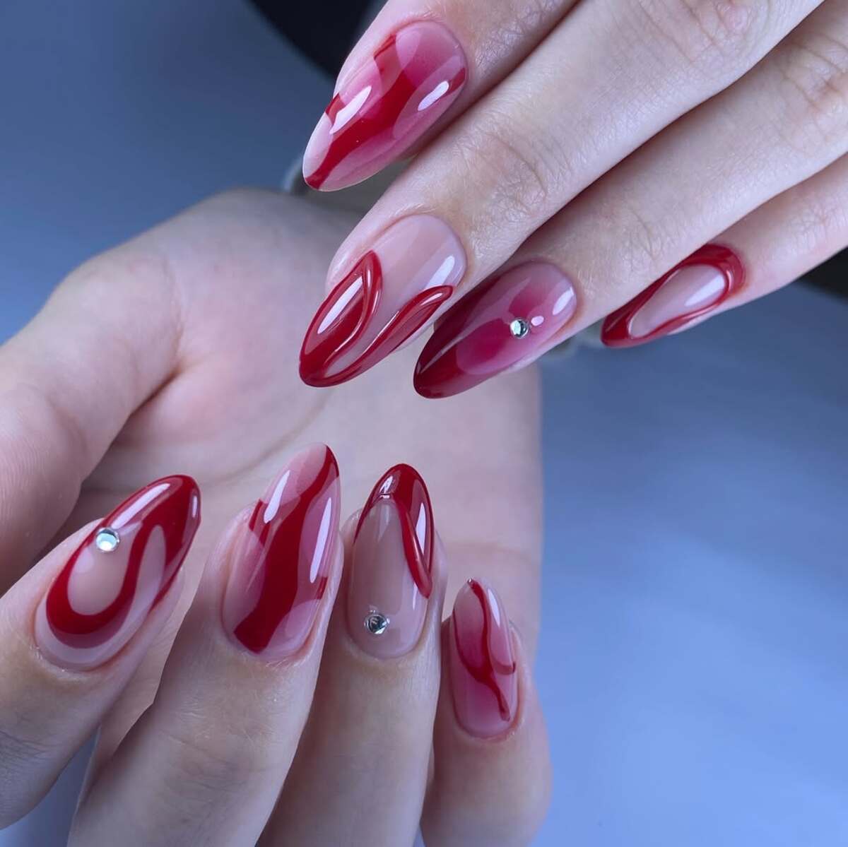 11. Glossy Red Swirls with Rhinestones