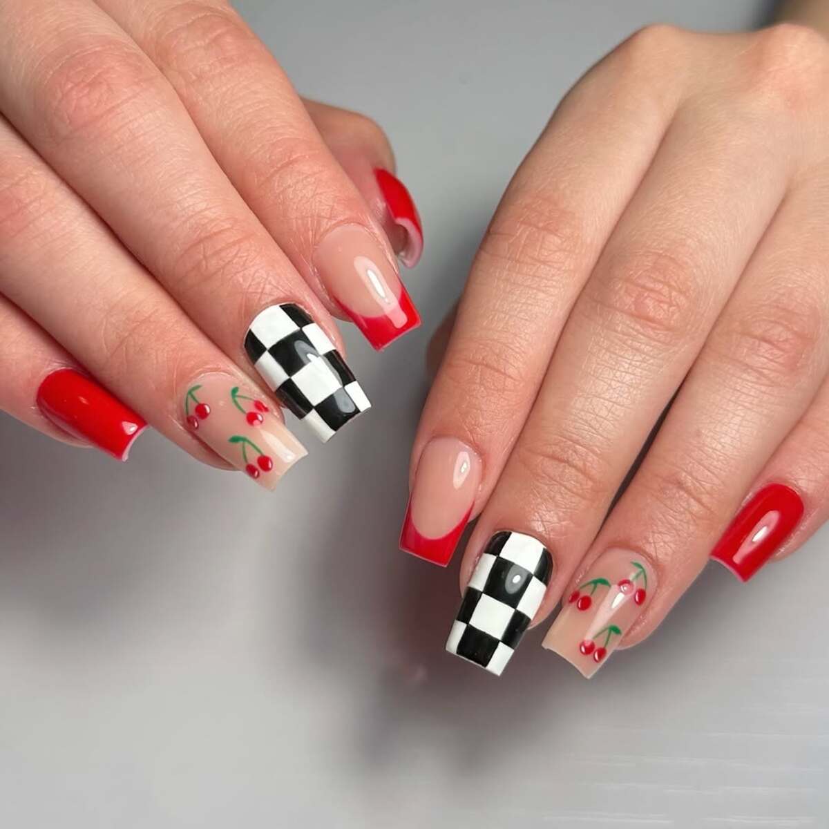 6. Cherry-Inspired Nail Art with Checkered Accents