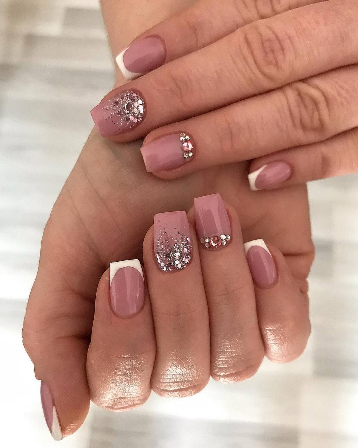 16. Modern French Tips with Rose Gold Embellishments
