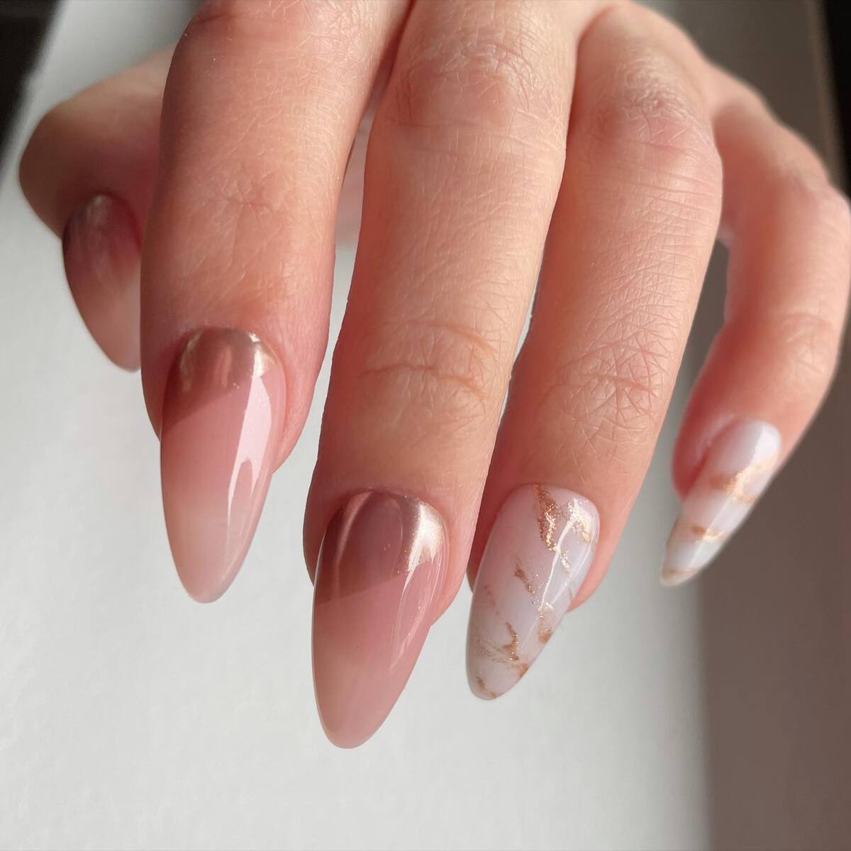 3. Elegant Rose Gold and Marble Stiletto Nails